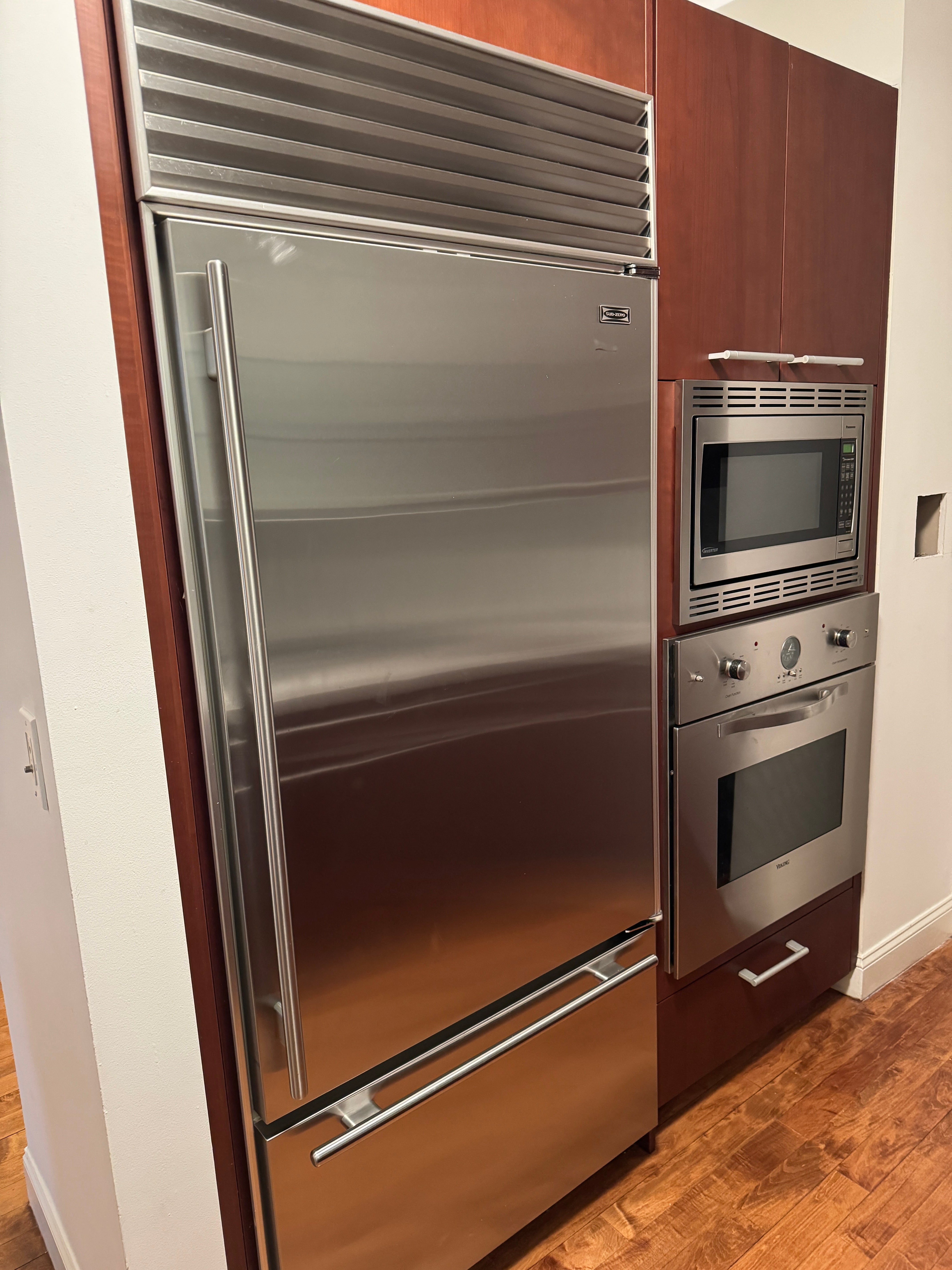 Poggenpohl Brown Toned Transitional Kitchen with Marble Countertops and Appliances