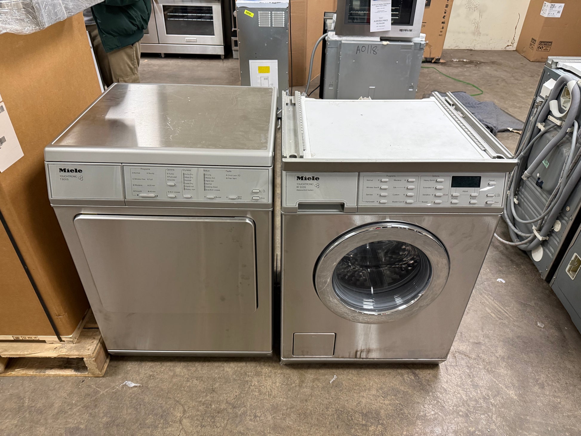 Miele 24 inch stainless steel front load washer and dryer stacked with kit