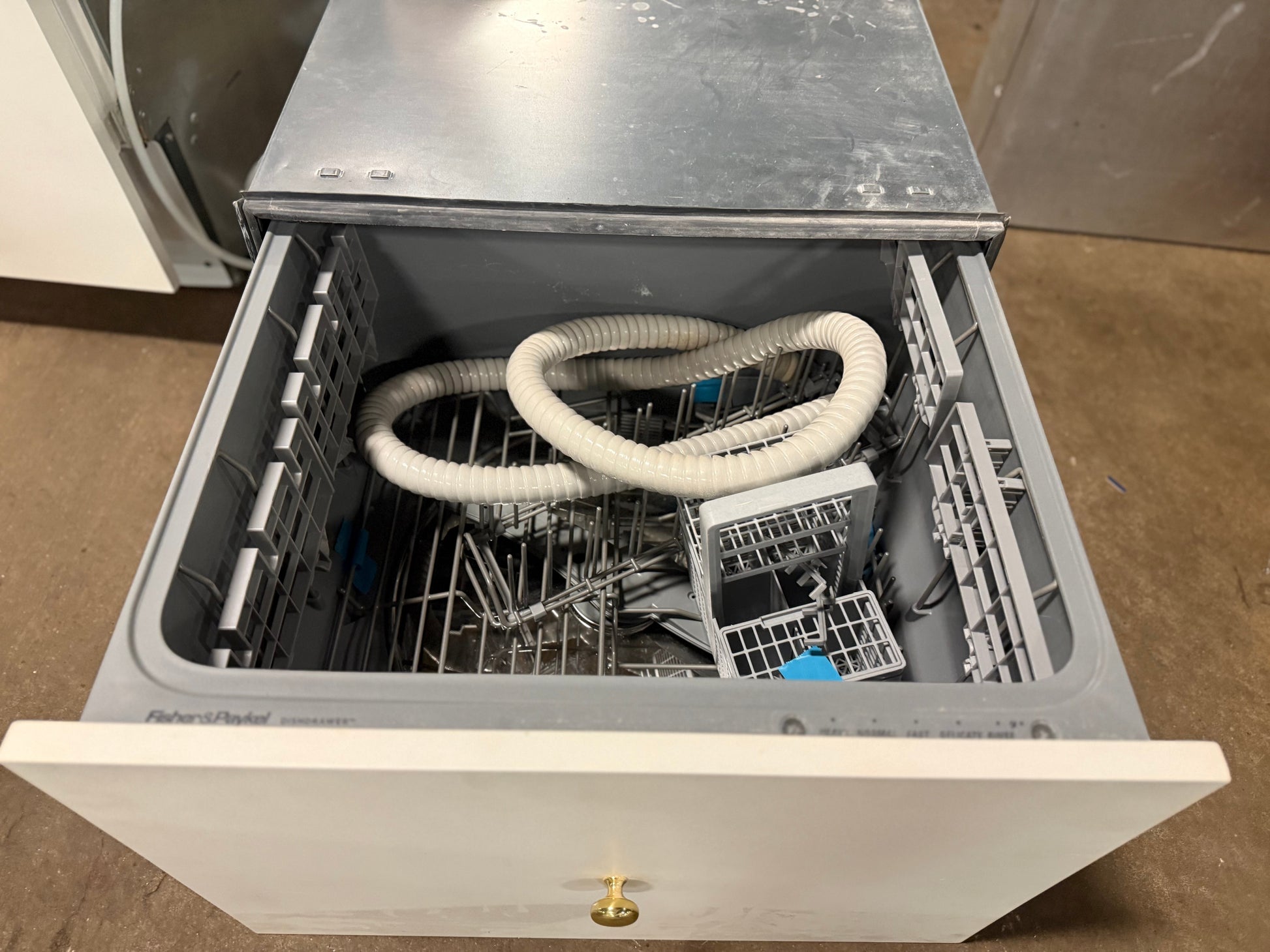 Interior view of stainless steel tub and racks in Fisher Paykel 24 inch DishDrawer