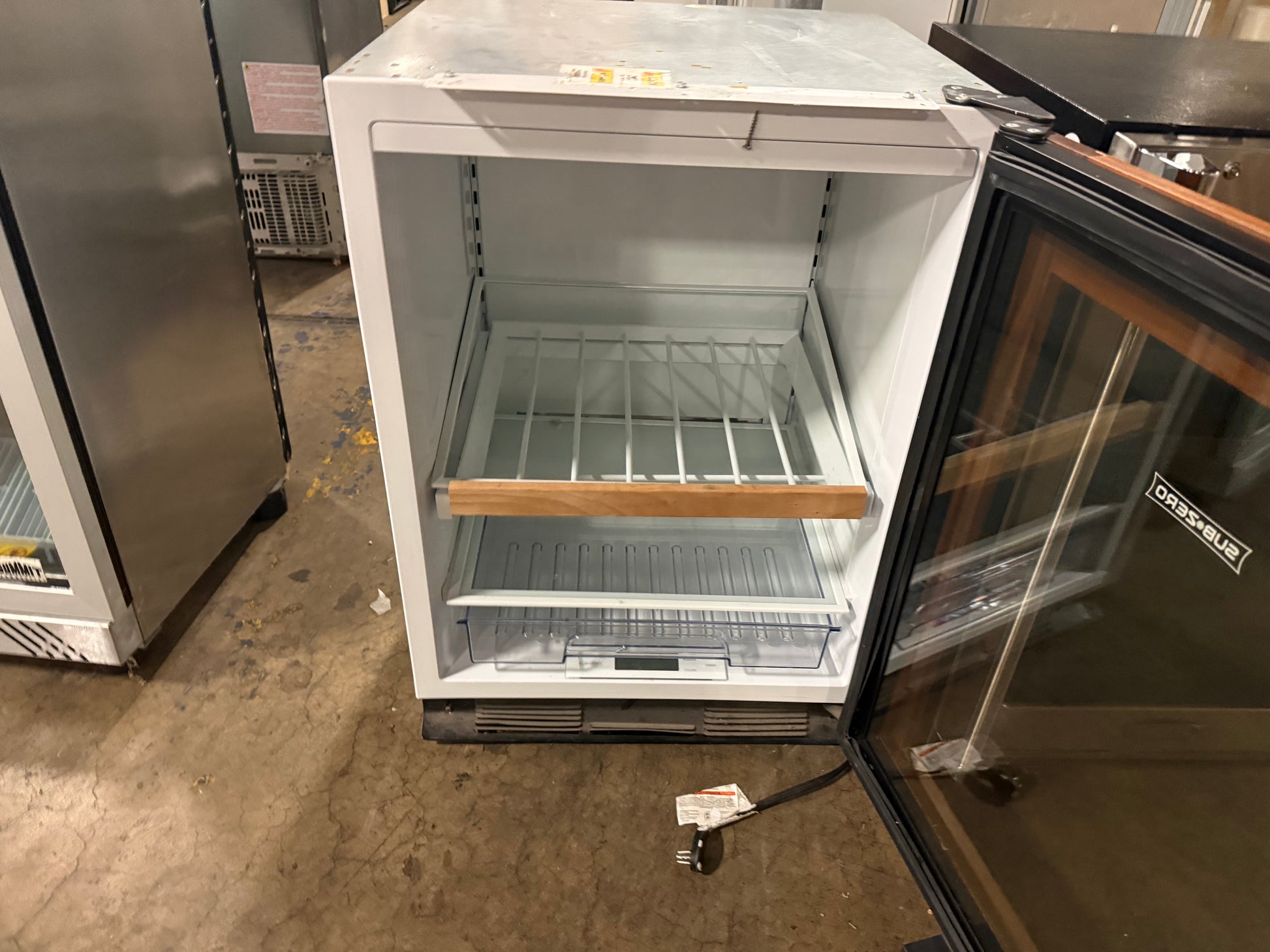 Custom integrated luxury beverage refrigerator with glass door and wine racks