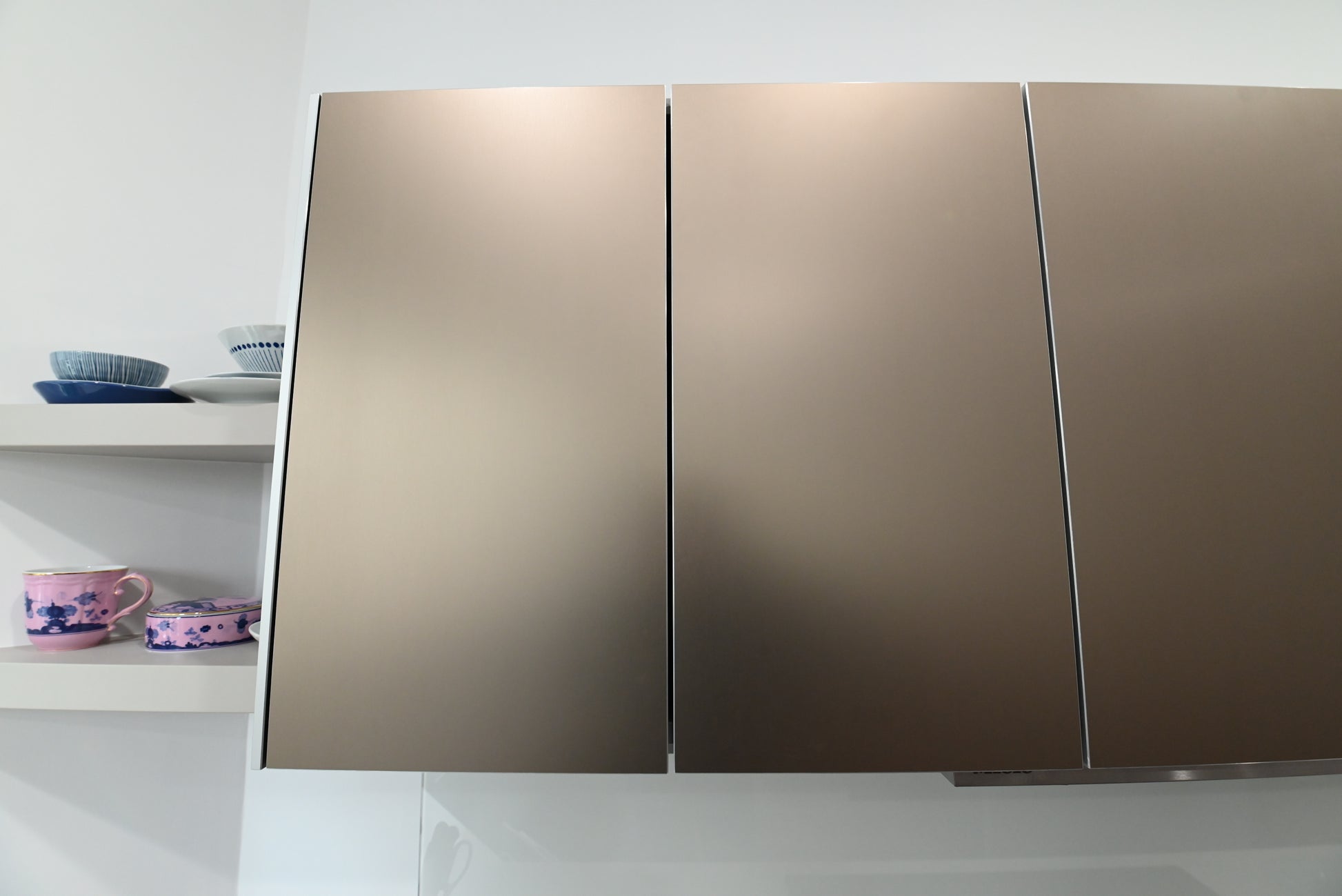 Bulthaup Modern Metallic Bronze Upper Cabinets with Glass Backsplash and Miele Hood Insert