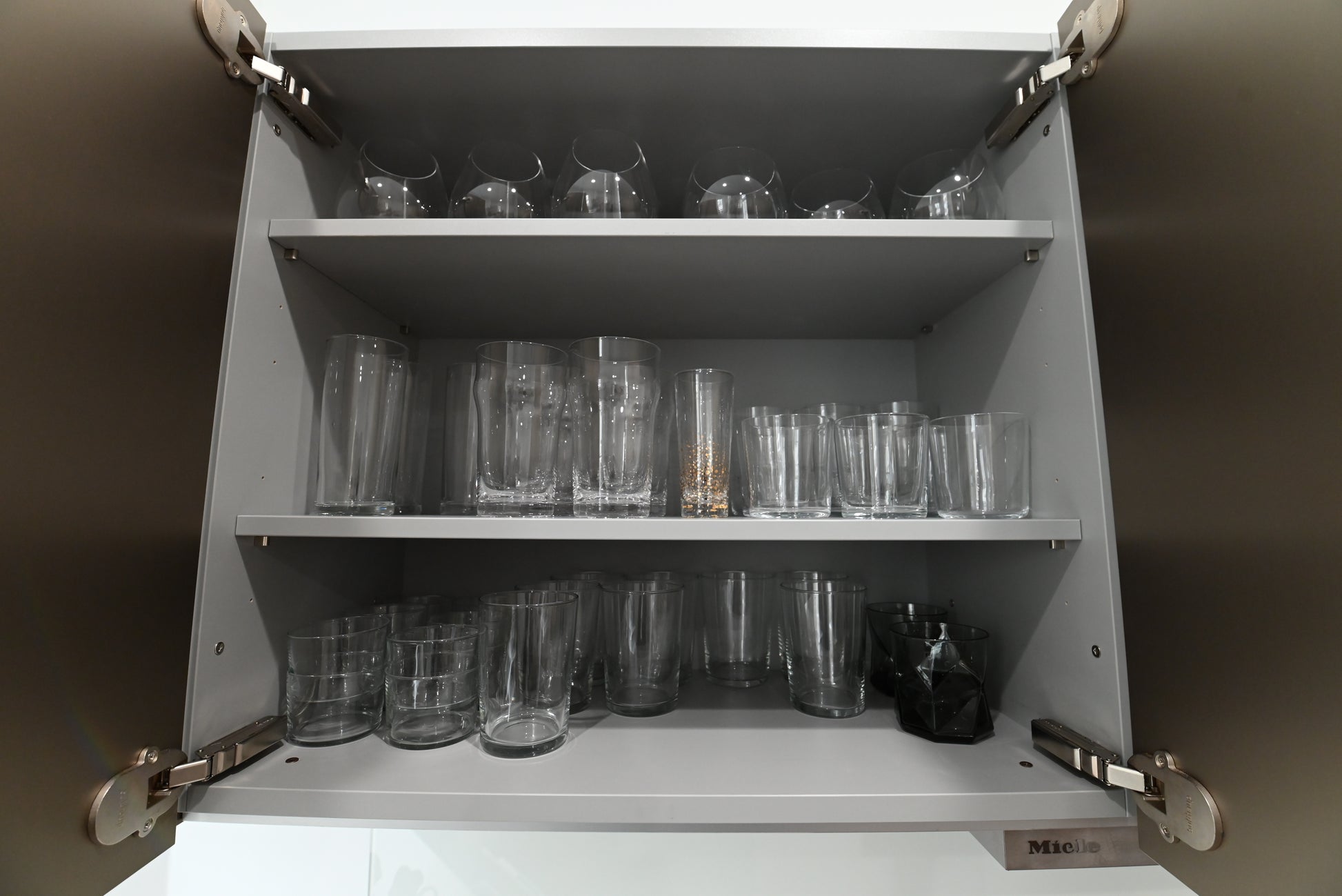 Bulthaup Modern Metallic Bronze Upper Cabinets with Glass Backsplash and Miele Hood Insert