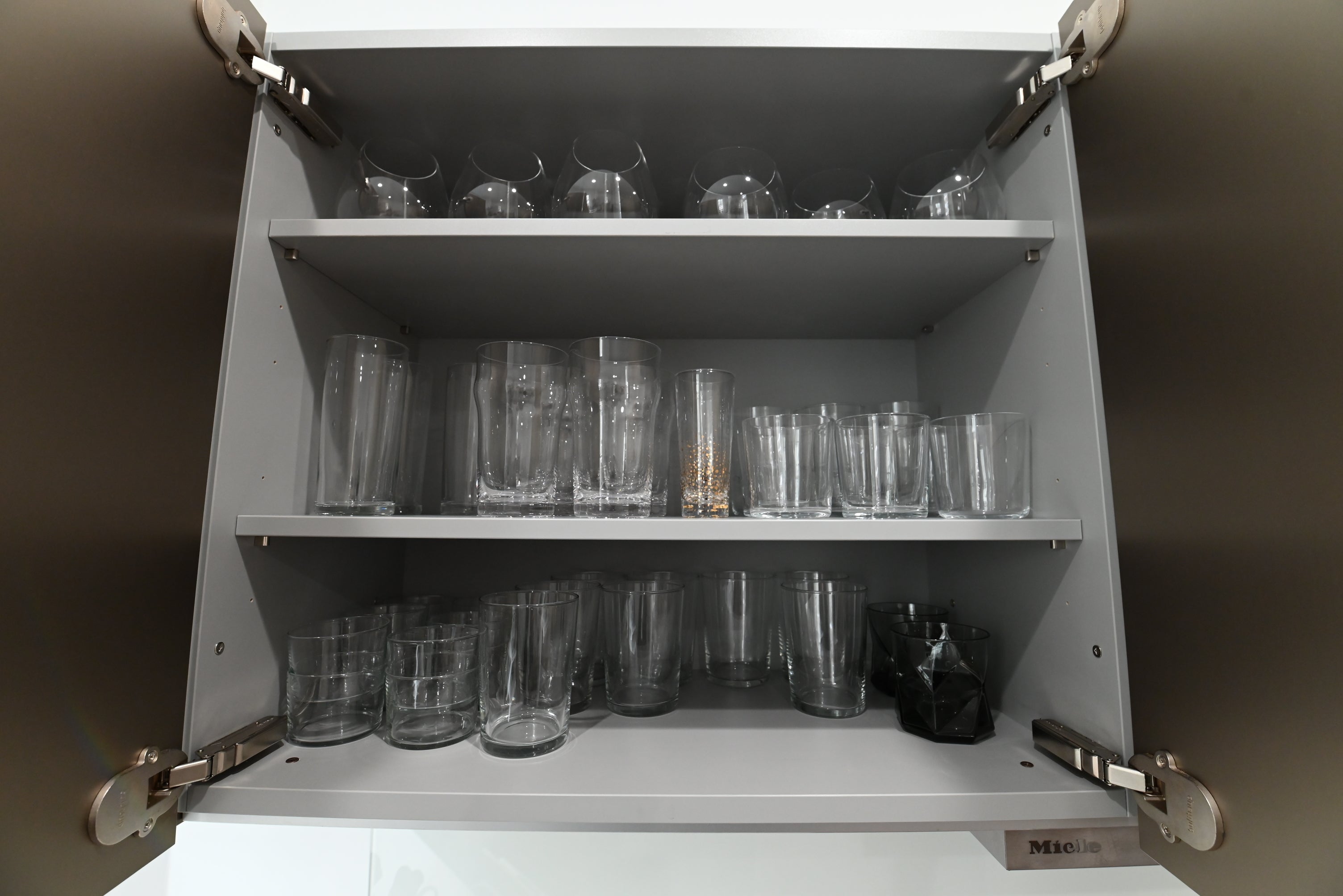 Bulthaup Modern Metallic Bronze Upper Cabinets with Glass Backsplash and Miele Hood Insert