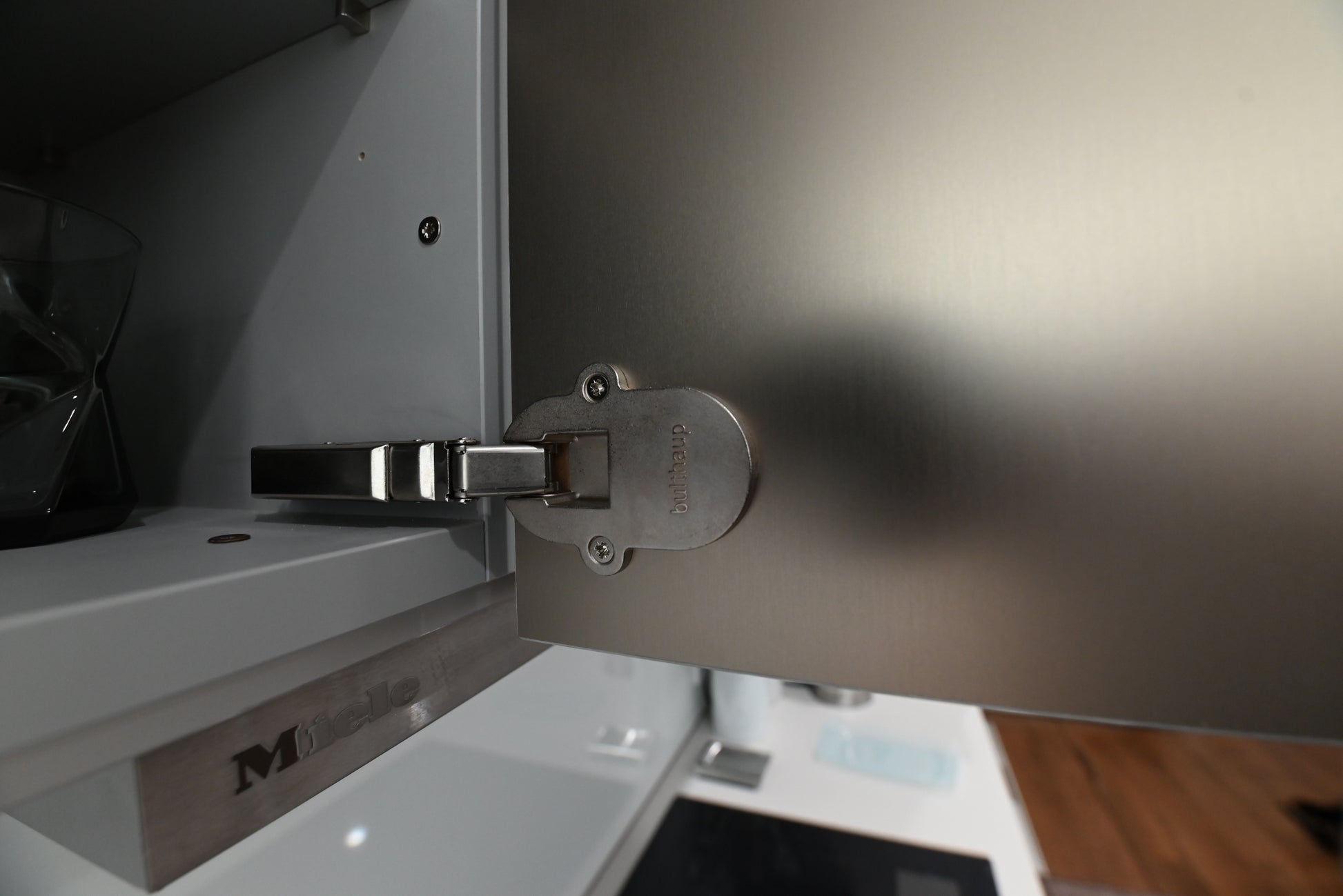 Bulthaup Modern Metallic Bronze Upper Cabinets with Glass Backsplash and Miele Hood Insert