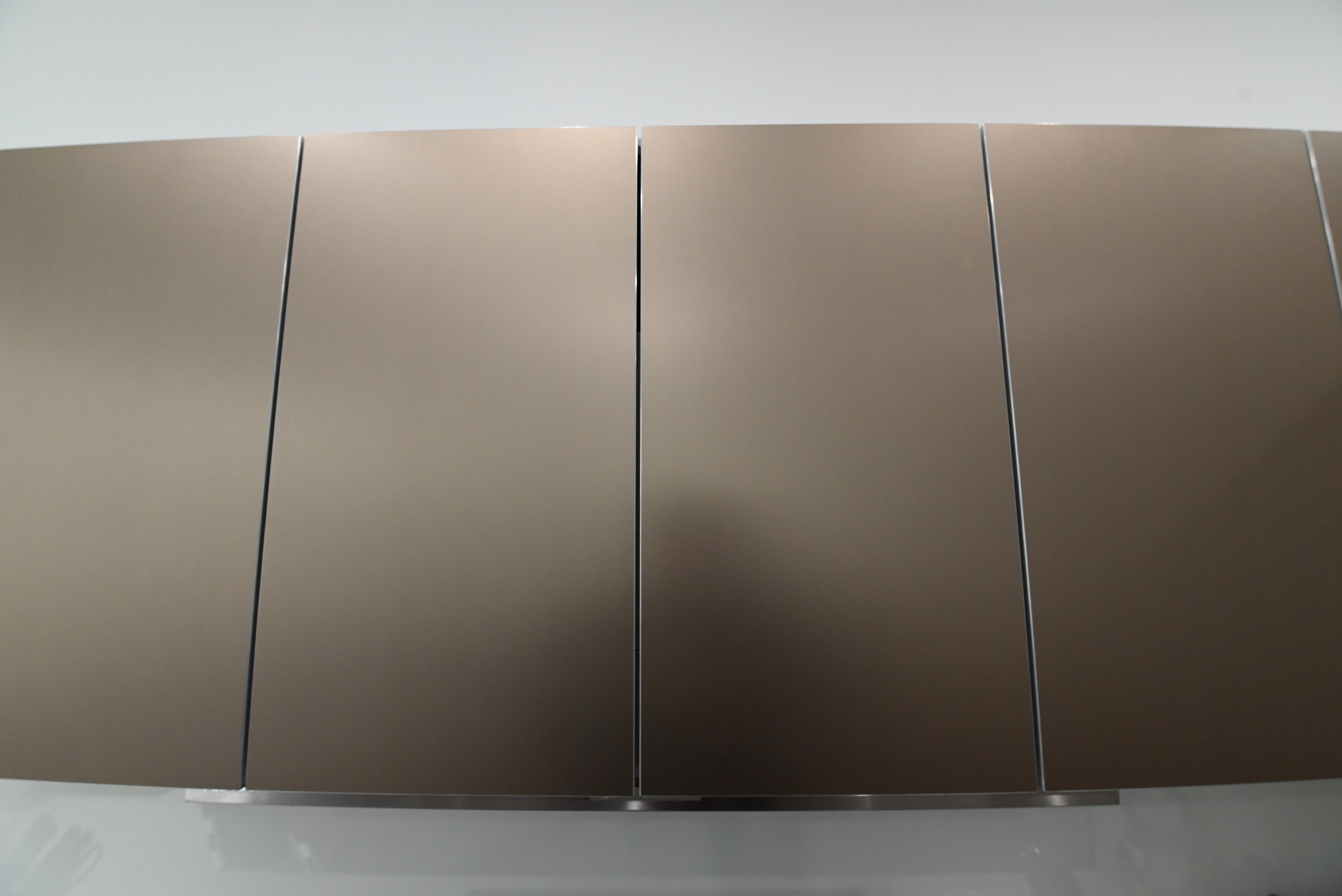 Bulthaup Modern Metallic Bronze Upper Cabinets with Glass Backsplash and Miele Hood Insert