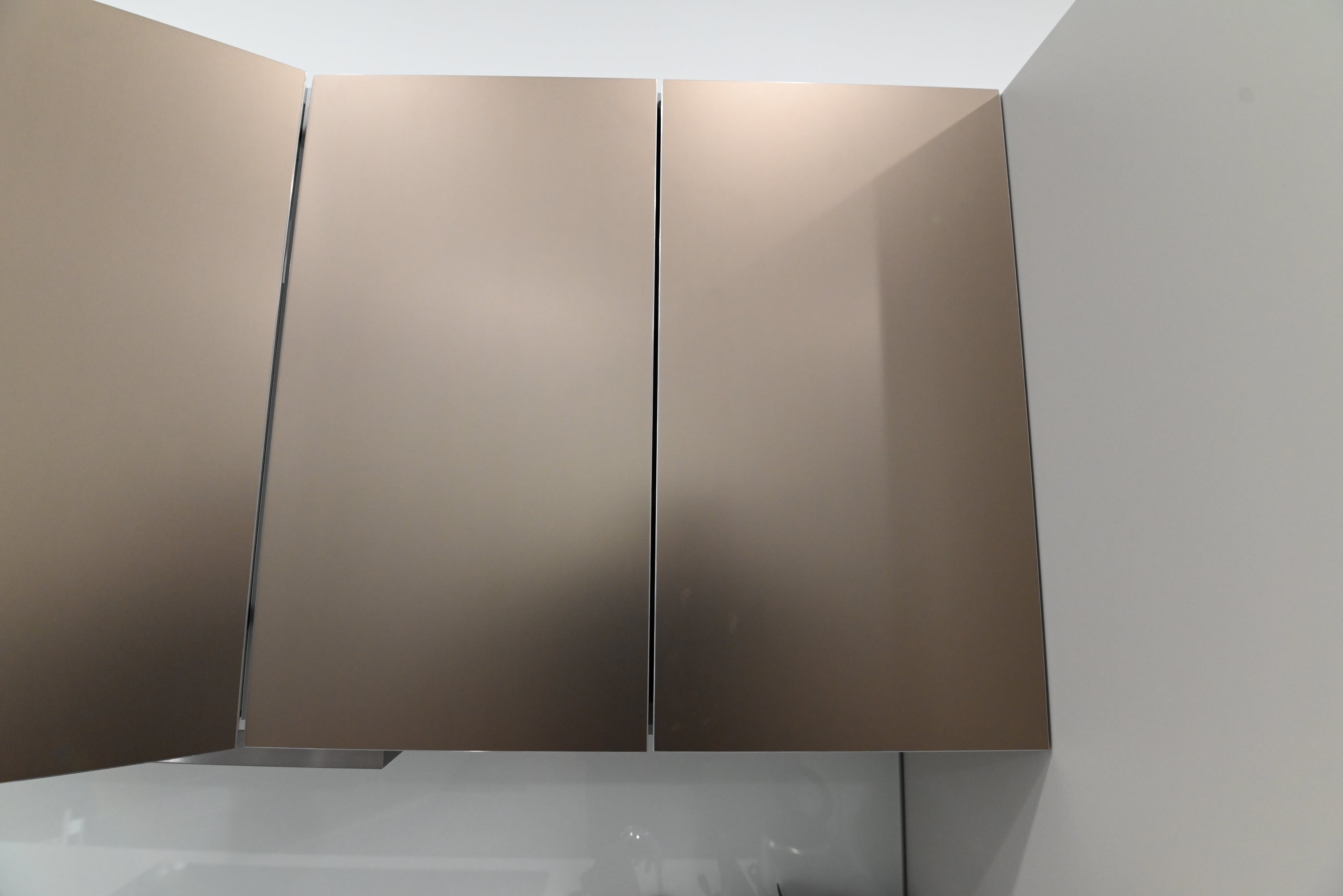 Bulthaup Modern Metallic Bronze Upper Cabinets with Glass Backsplash and Miele Hood Insert