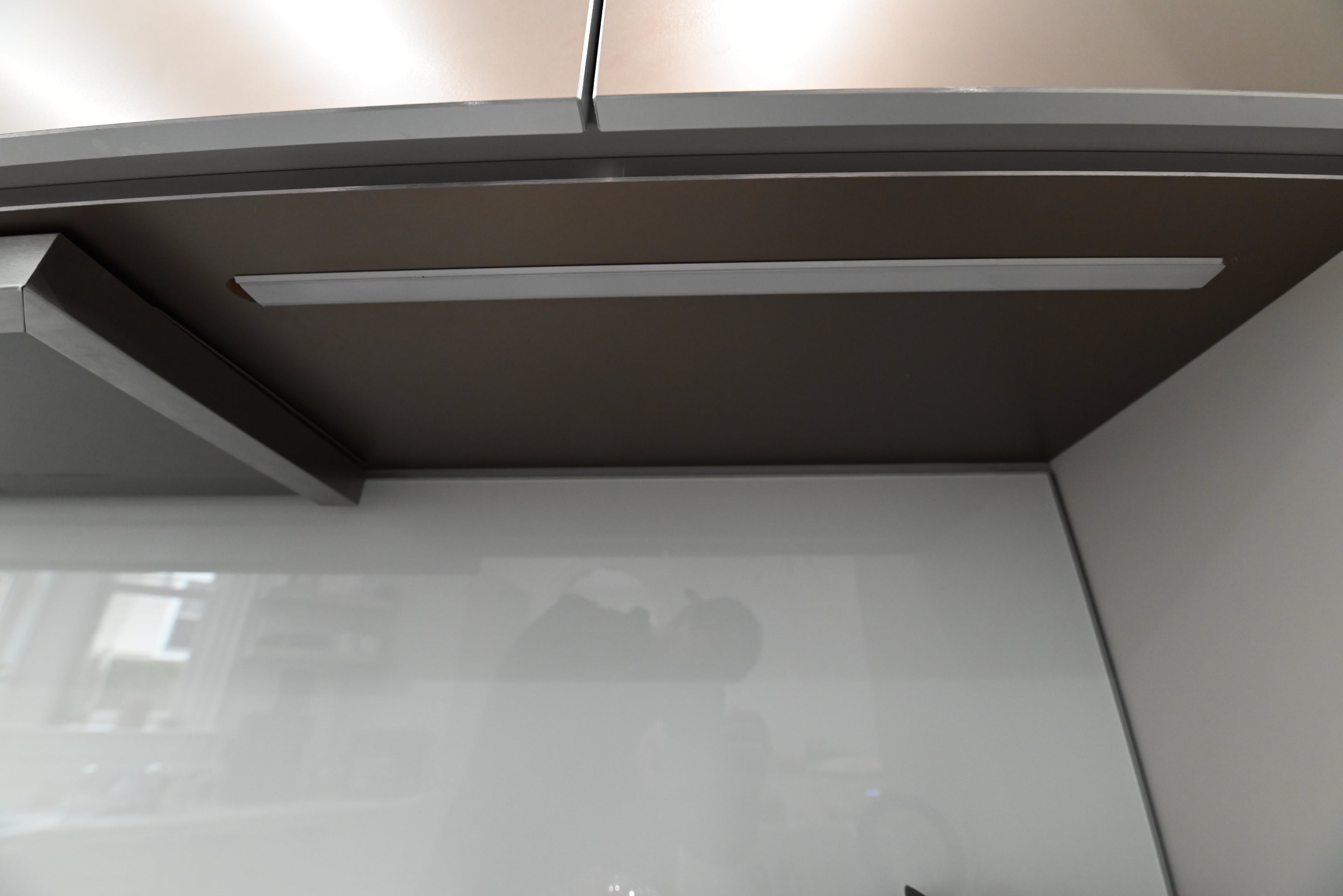 Bulthaup Modern Metallic Bronze Upper Cabinets with Glass Backsplash and Miele Hood Insert