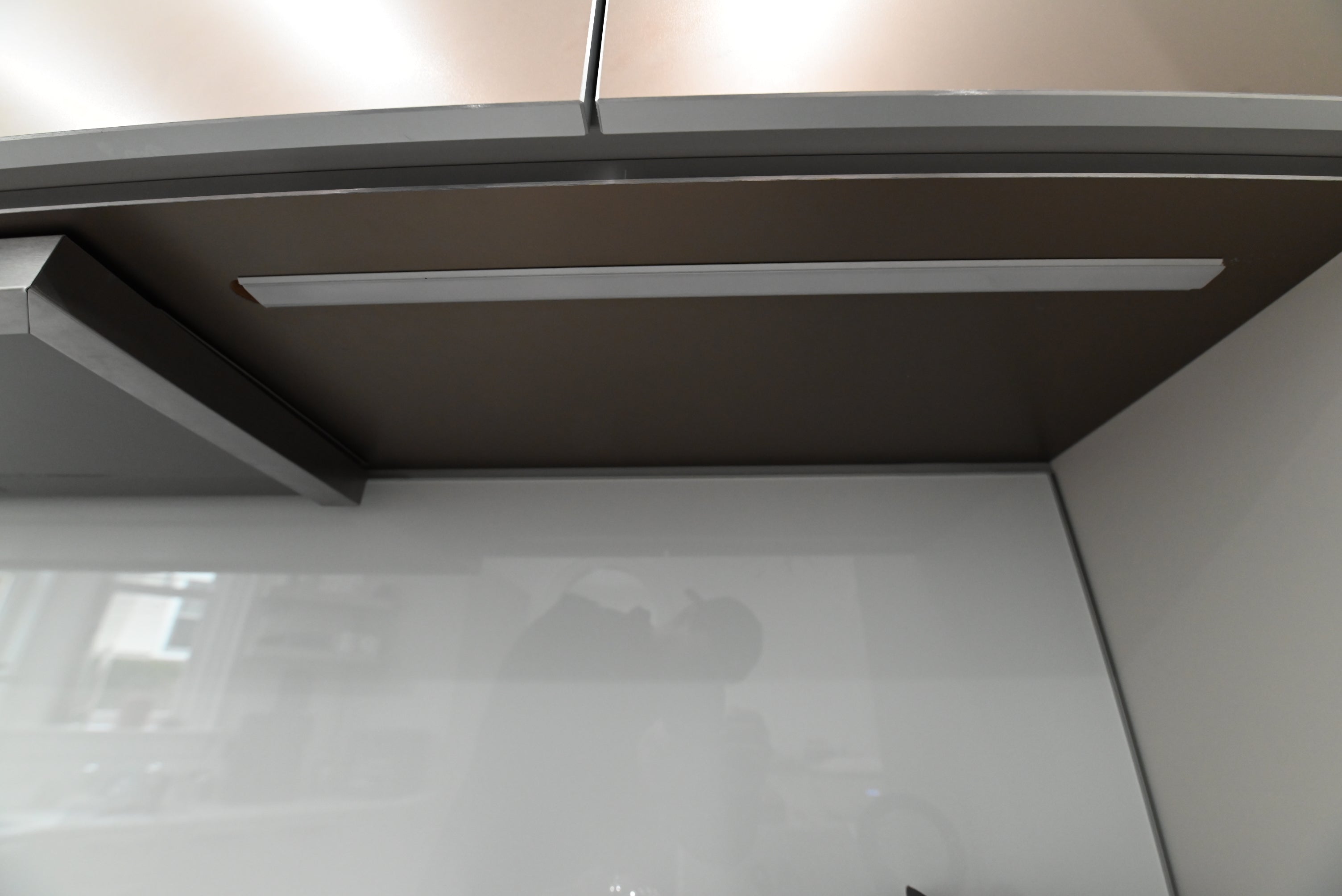 Bulthaup Modern Metallic Bronze Upper Cabinets with Glass Backsplash and Miele Hood Insert