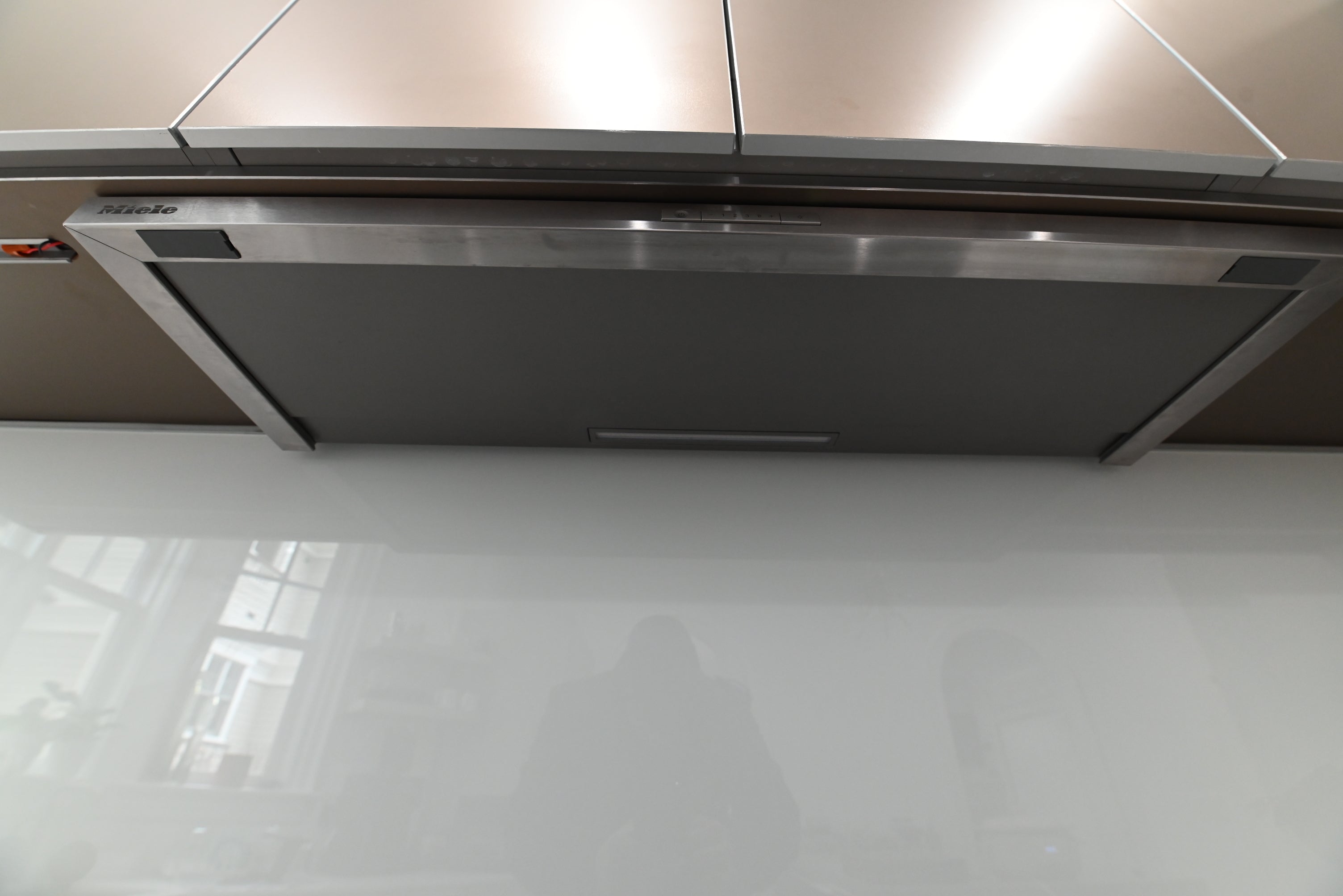 Bulthaup Modern Metallic Bronze Upper Cabinets with Glass Backsplash and Miele Hood Insert