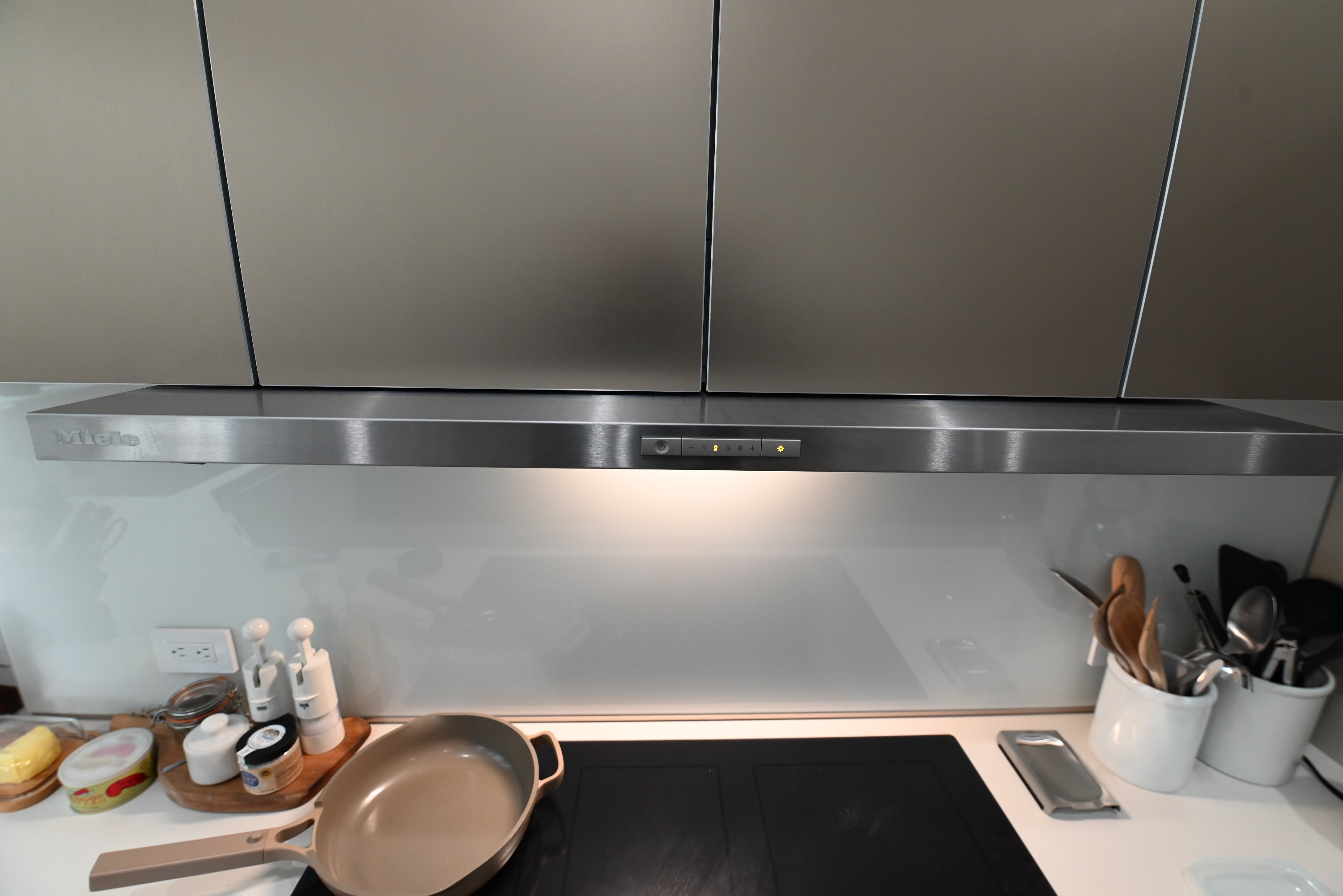 Bulthaup Modern Metallic Bronze Upper Cabinets with Glass Backsplash and Miele Hood Insert
