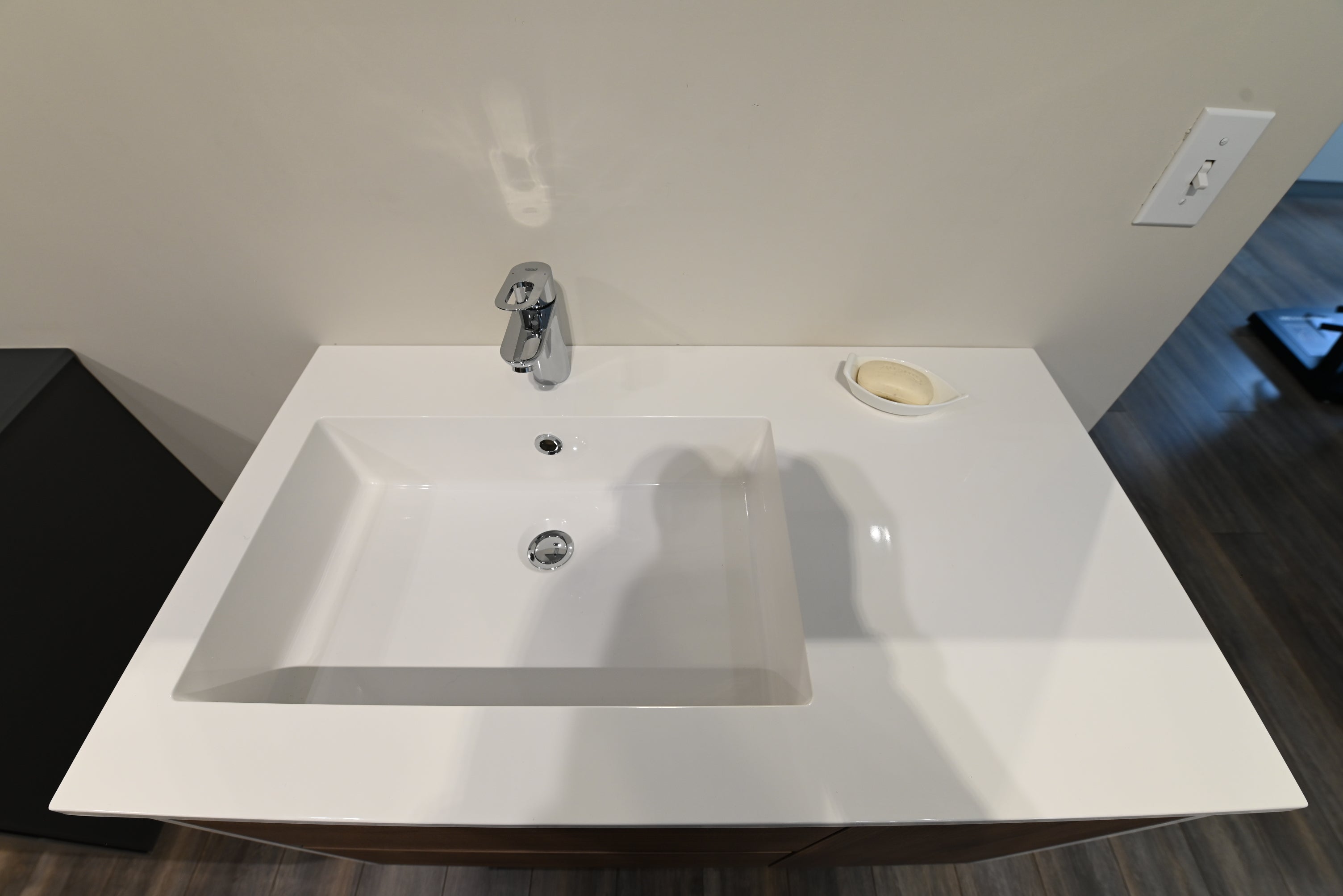 Luxury wall mounted modern light oak wood bathroom vanity open showing handleless soft close drawers with P trap cutout
