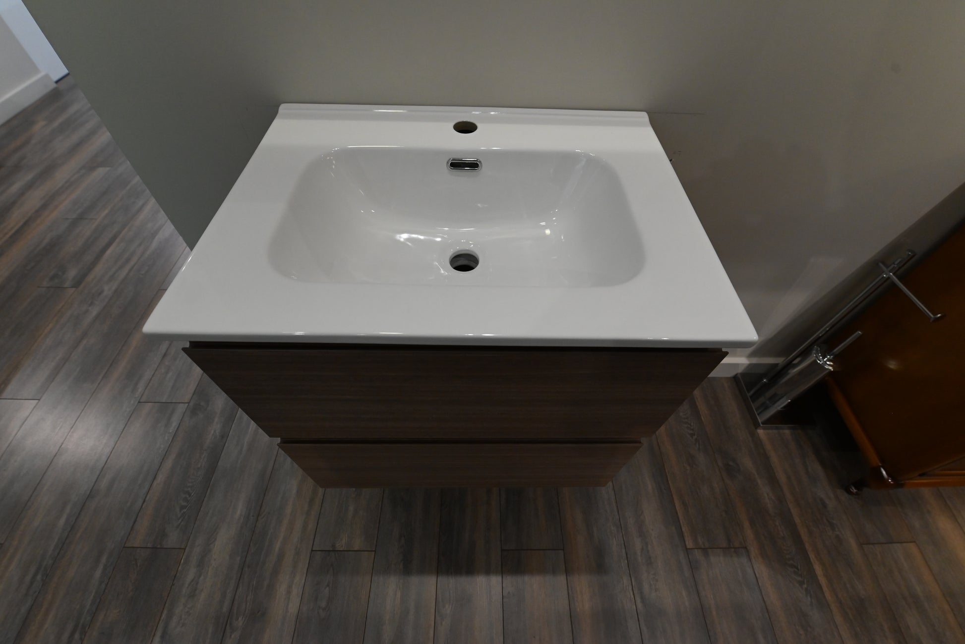 Luxury wall mounted compact modern bathroom vanity open showing dual soft close drawers with P trap cutout
