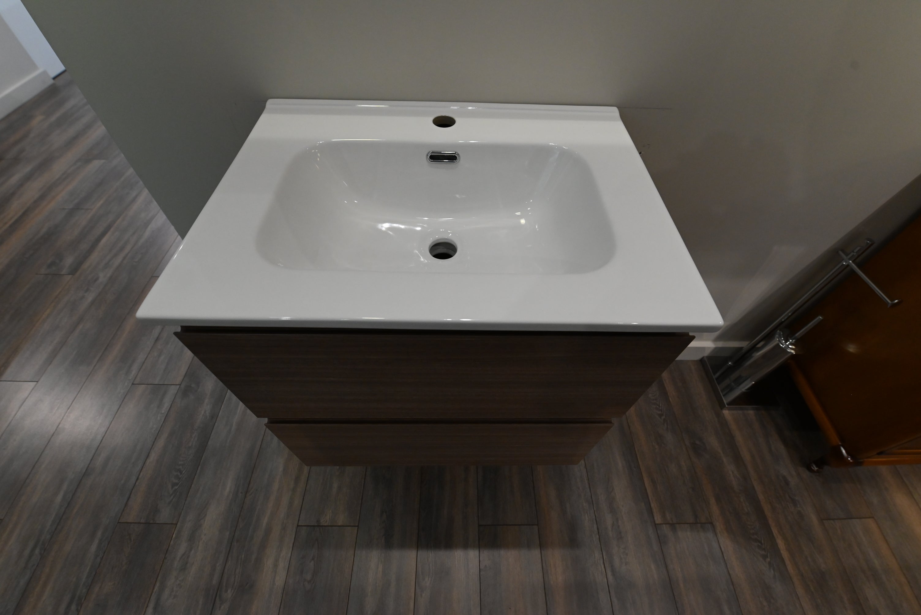 Luxury wall mounted compact modern bathroom vanity open showing dual soft close drawers with P trap cutout