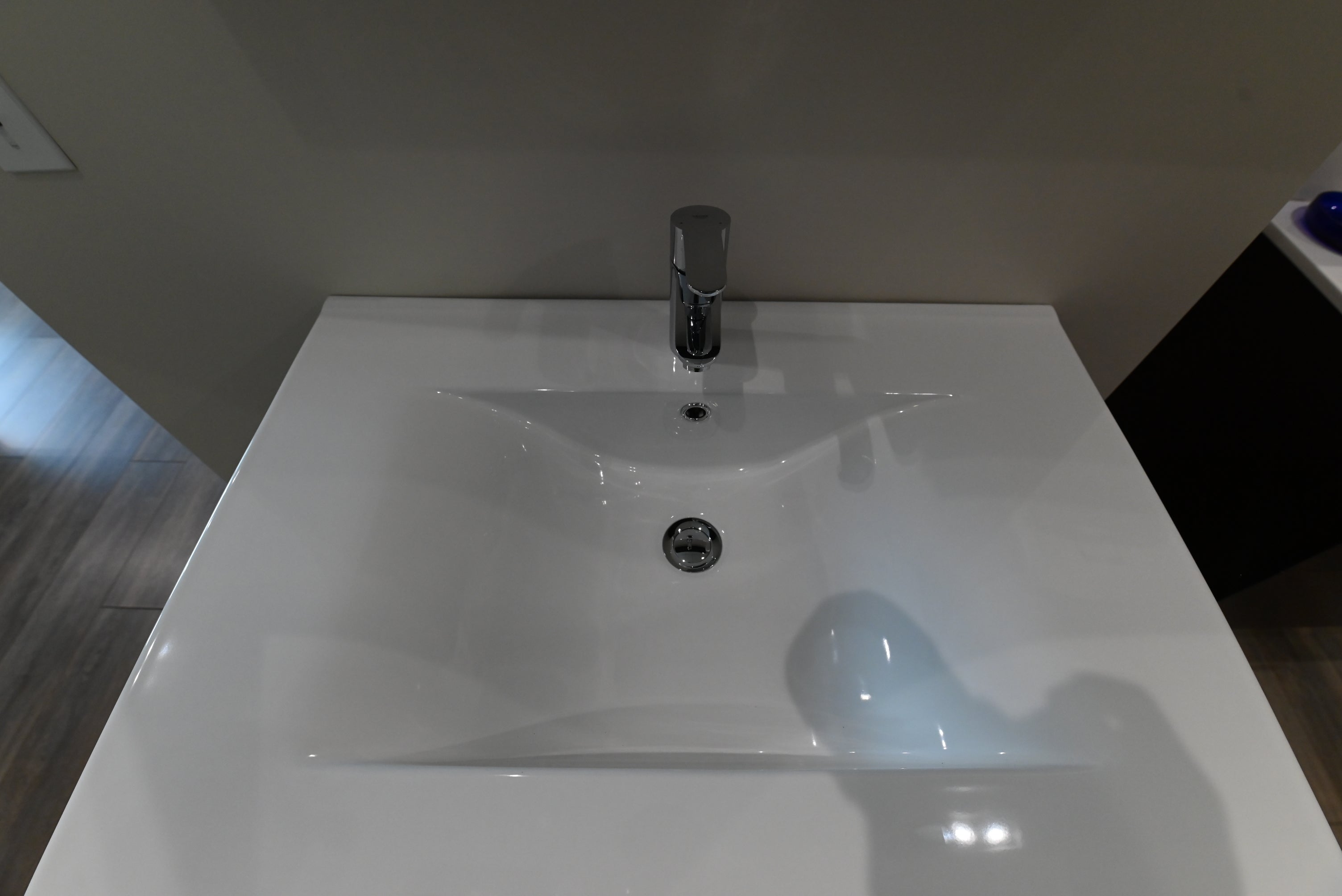 Luxury wall mounted transitional bathroom vanity cabinet open showing dual soft close drawers with custom plumbing cutouts