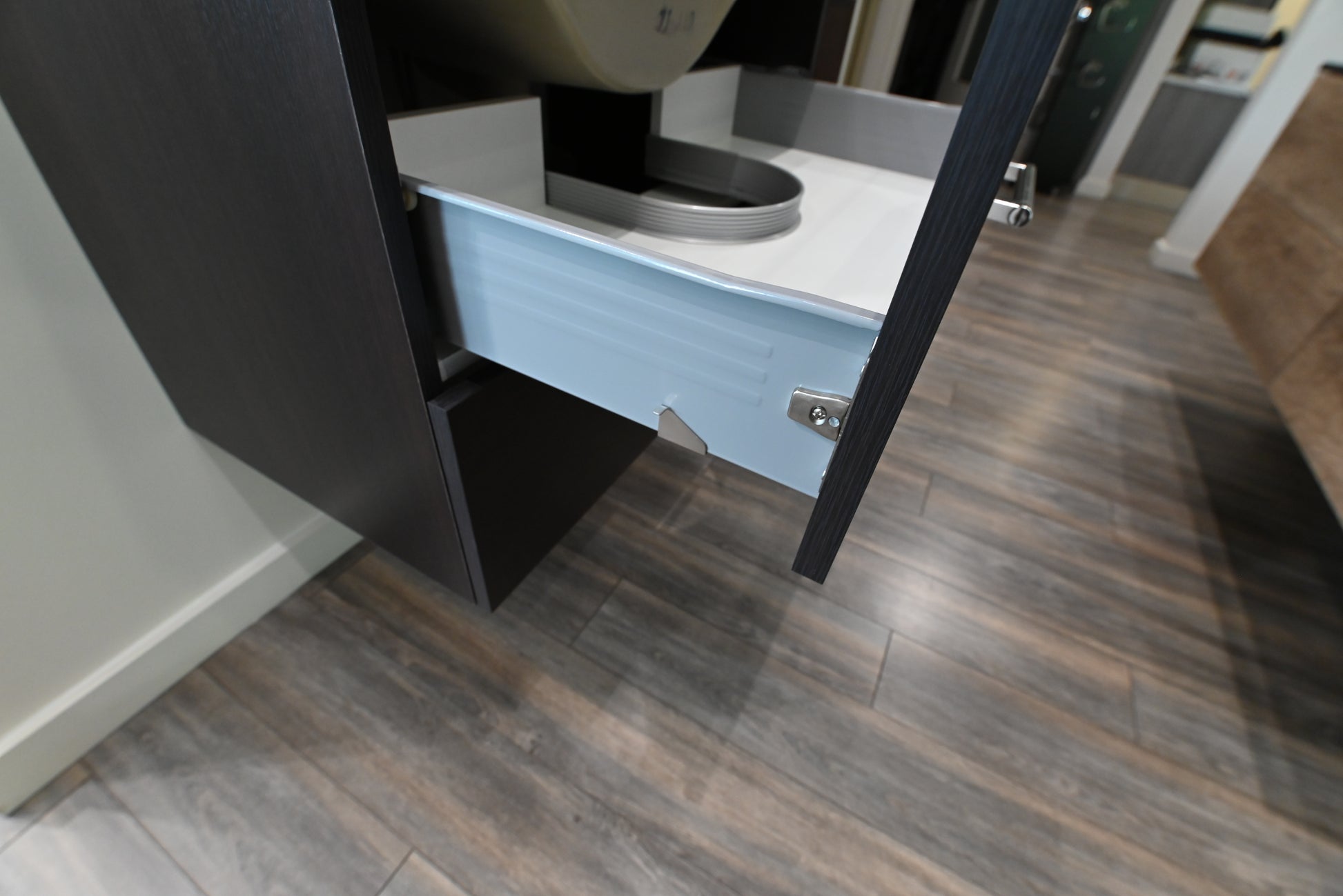 32 inch floating single basin bathroom vanity package sitting flush against a neutral tile wall backdrop