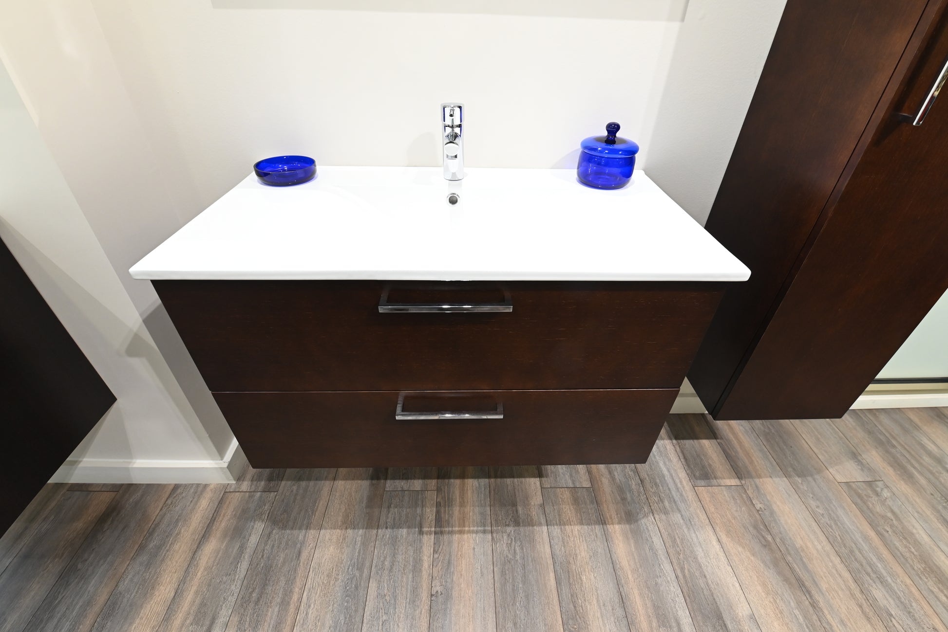 Luxury wall mounted natural wood grain bathroom vanity cabinet open showing soft close storage doors with plumbing cutout