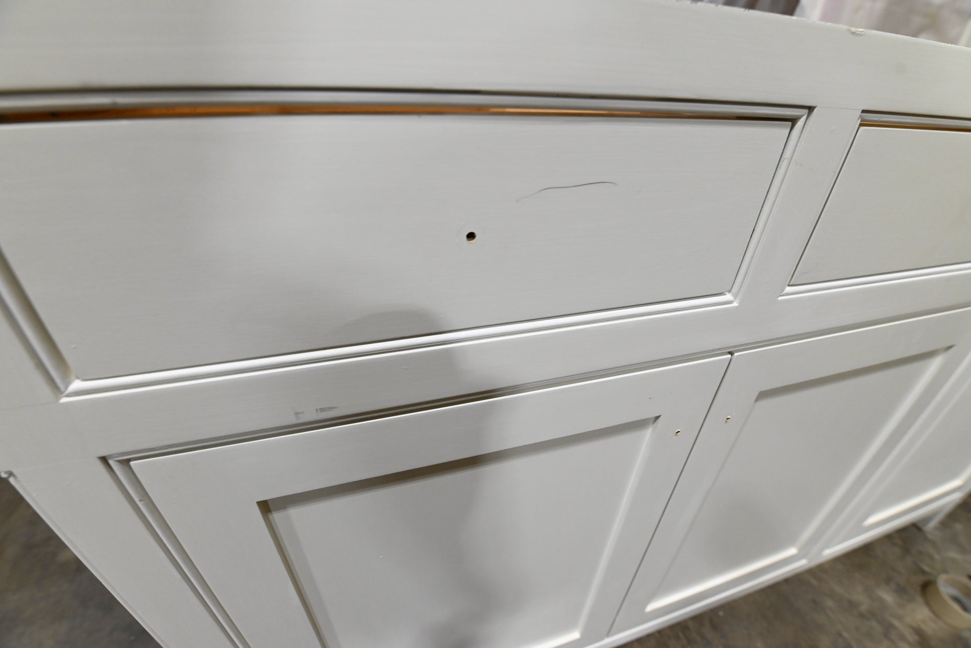 Traditional white custom kitchen cabinets in a clean, professional de-installation