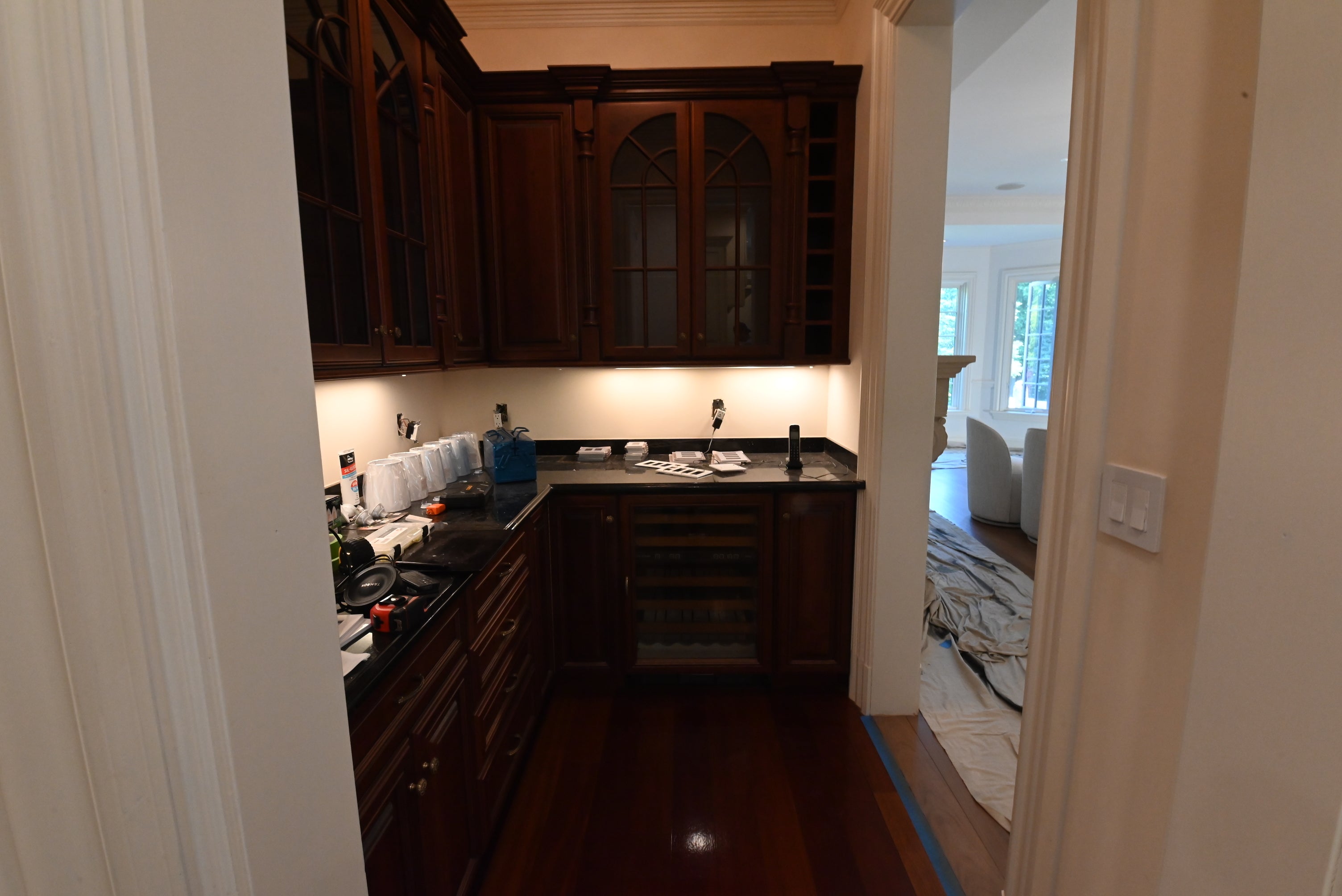 Pre owned stained wood butler pantry highlighting raised panel doors and dovetail drawers