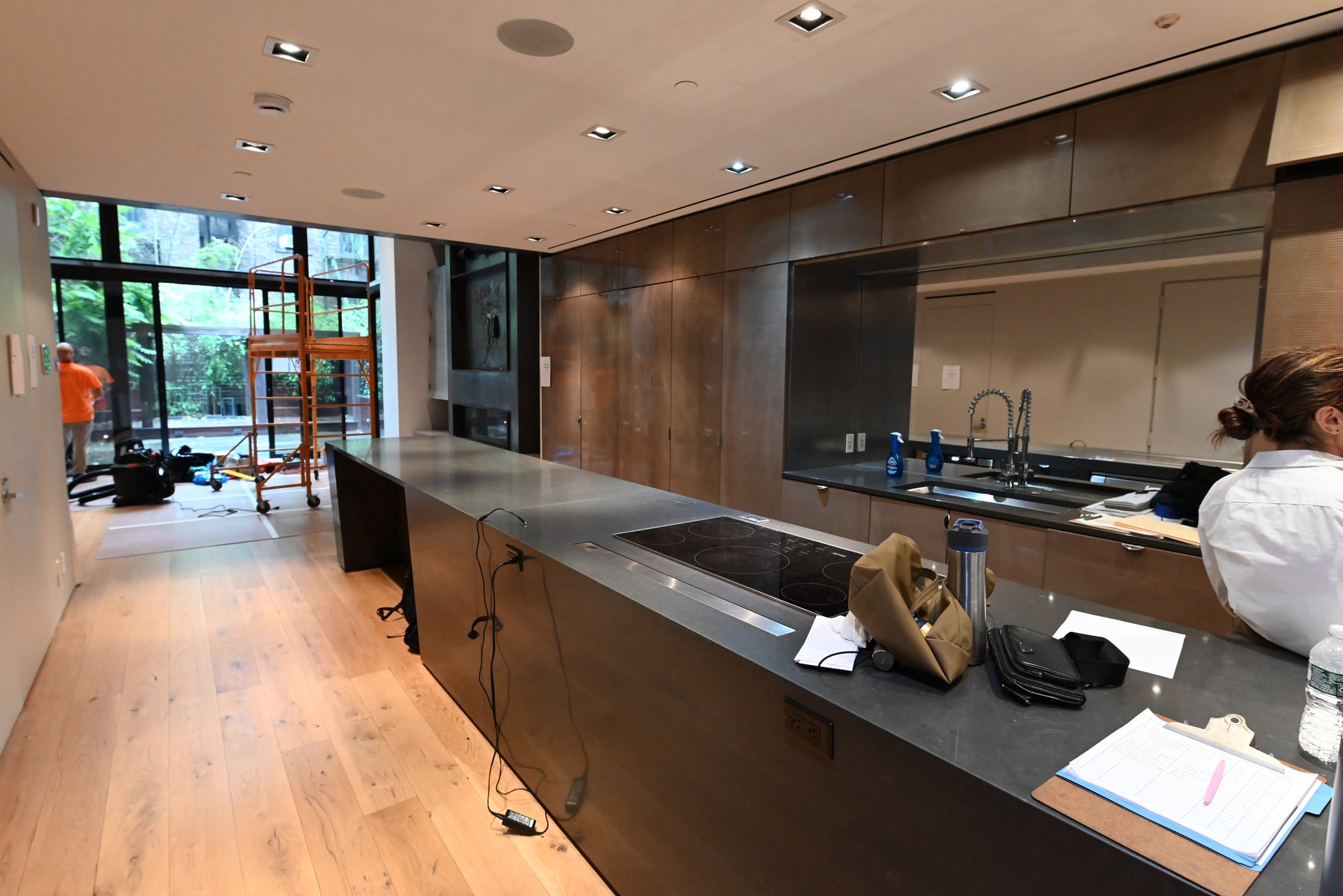 Luxury modern estate kitchen layout highlighting built in Gaggenau wall ovens and minimalist lines