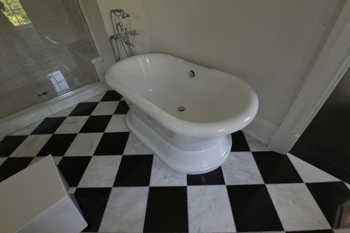 High-end residential bathroom soaking tub with clean sculptural silhouette