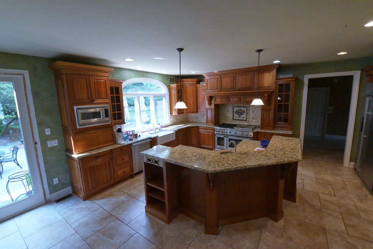 Aurora Circ traditional wood kitchen with granite island built in appliances and pendant lighting
