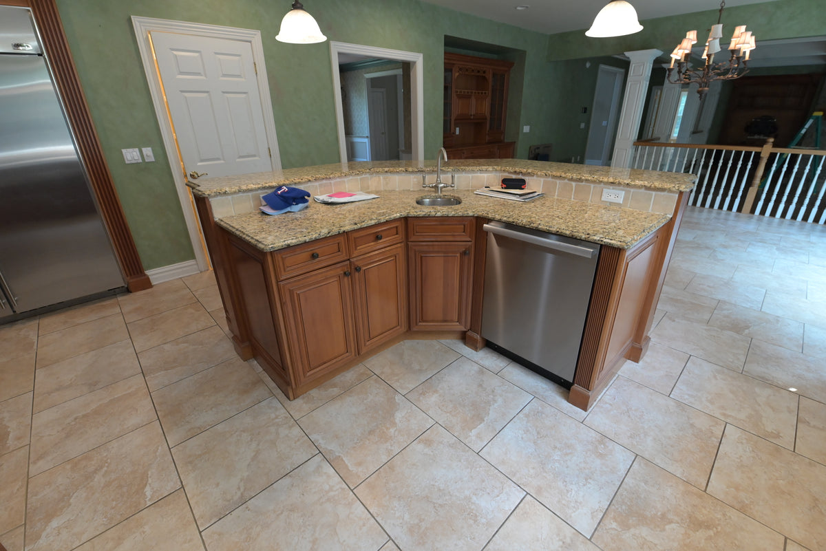 Aurora Circ traditional wooden kitchen island with raised panel cabinetry granite countertop sink and stainless steel dishwasher