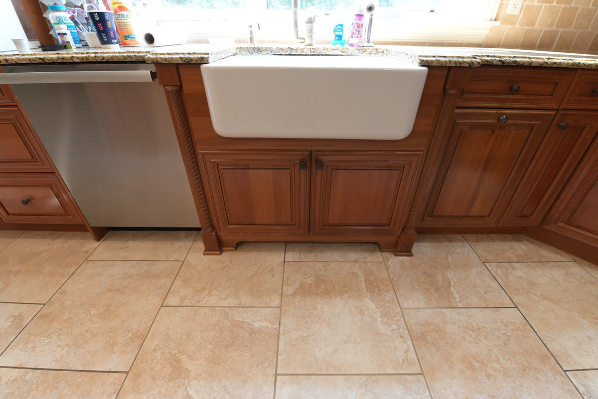 Aurora Circ traditional wooden kitchen cabinetry with a white farmhouse sink granite countertop and tiled floor