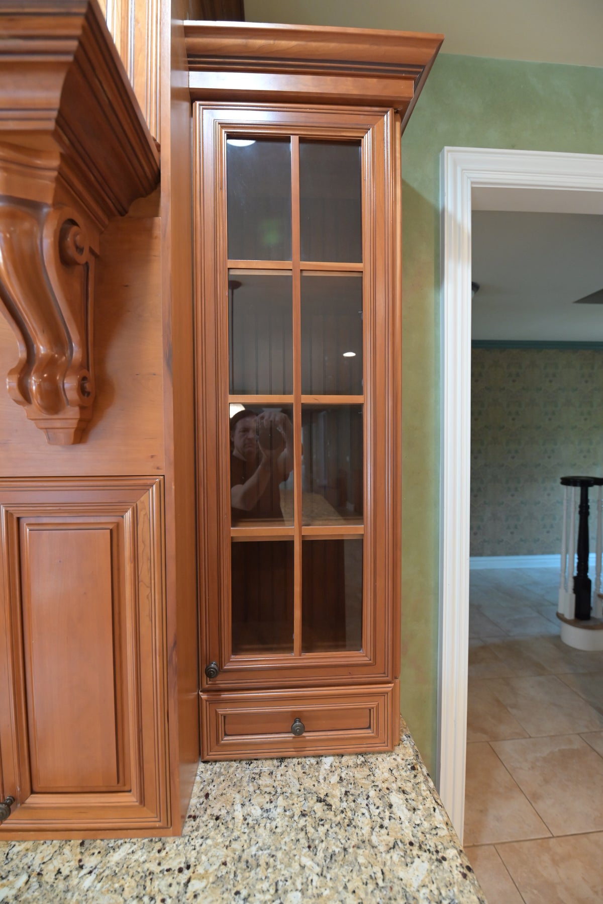 Aurora Circ traditional wood kitchen cabinet with mullioned glass door ornate molding and granite countertop
