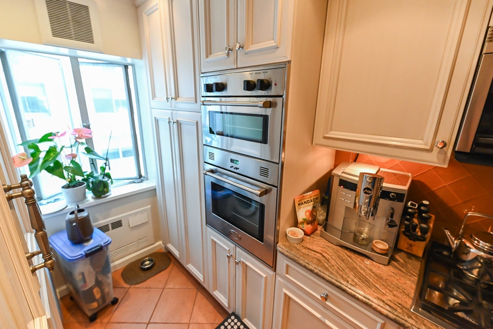 Wood-Mode Wonder: Traditional Light Cream Kitchen with Granite Countertops