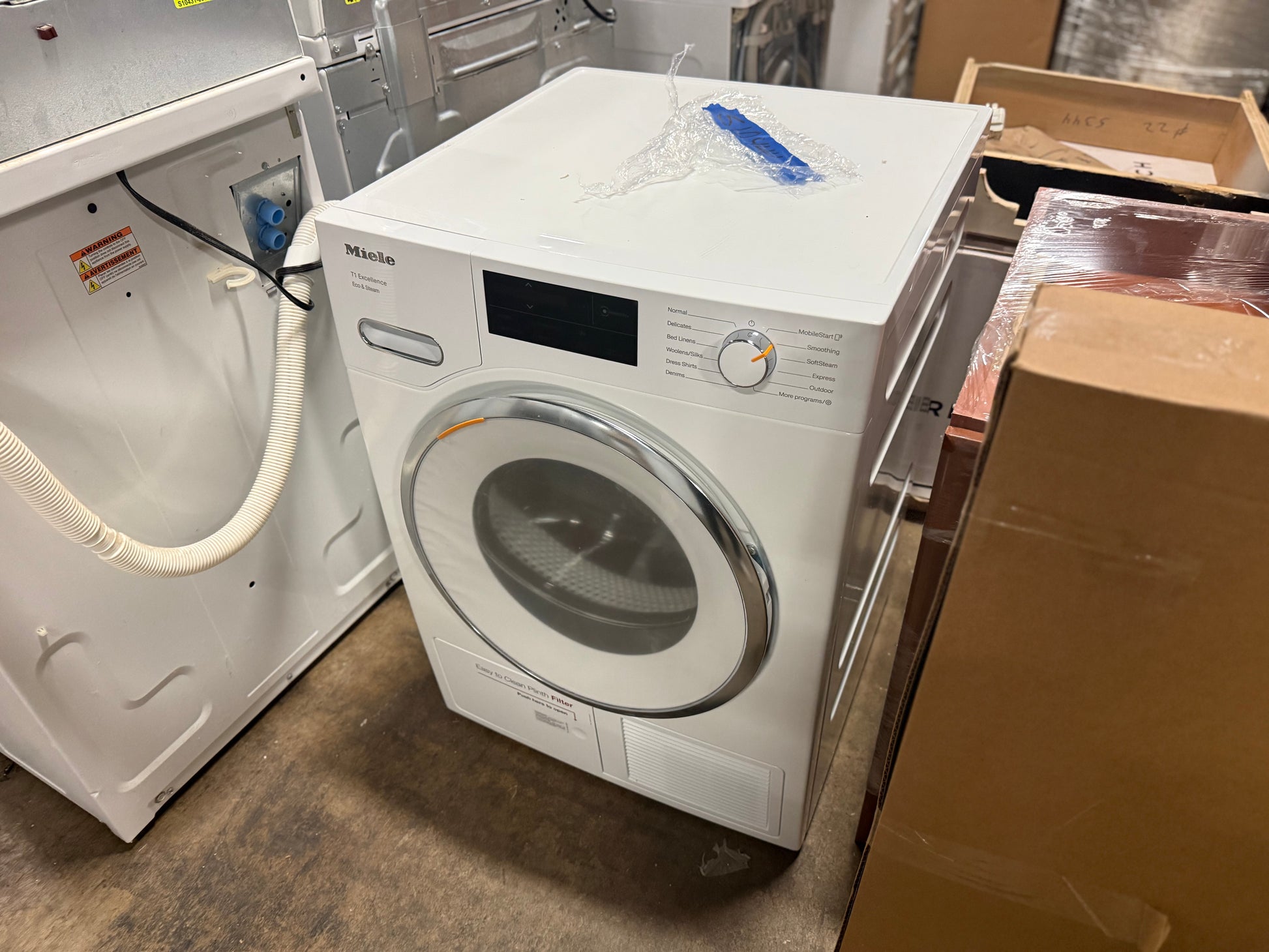 Stacked Miele Lotus White laundry units for small space efficiency