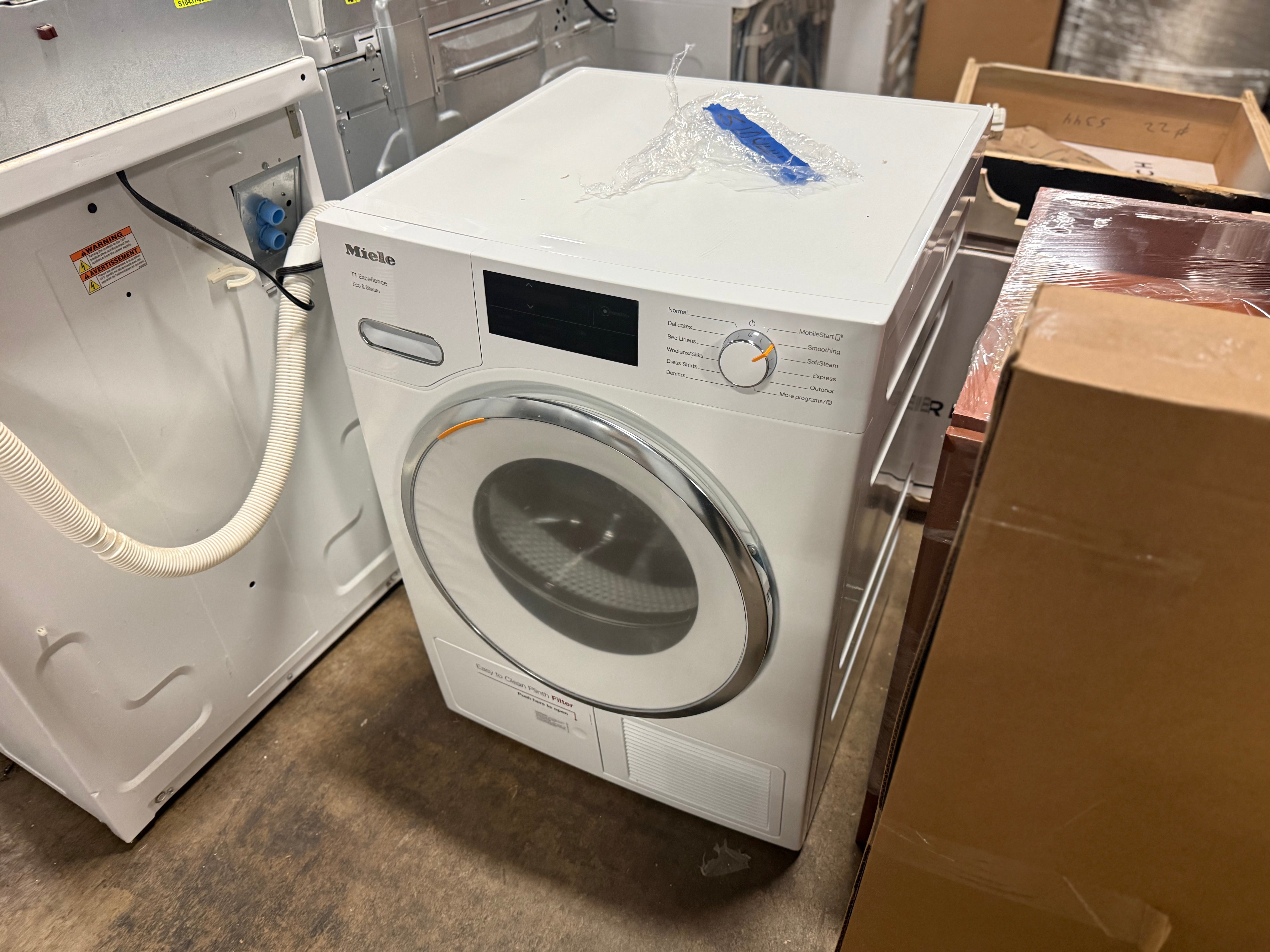 Stacked Miele Lotus White laundry units for small space efficiency