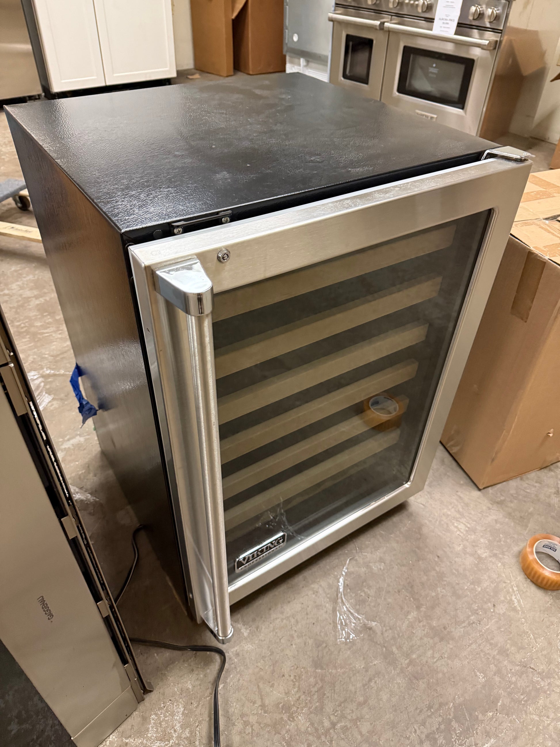 Built-in Viking 24 inch wine cellar with maple-faced racks for home bars
