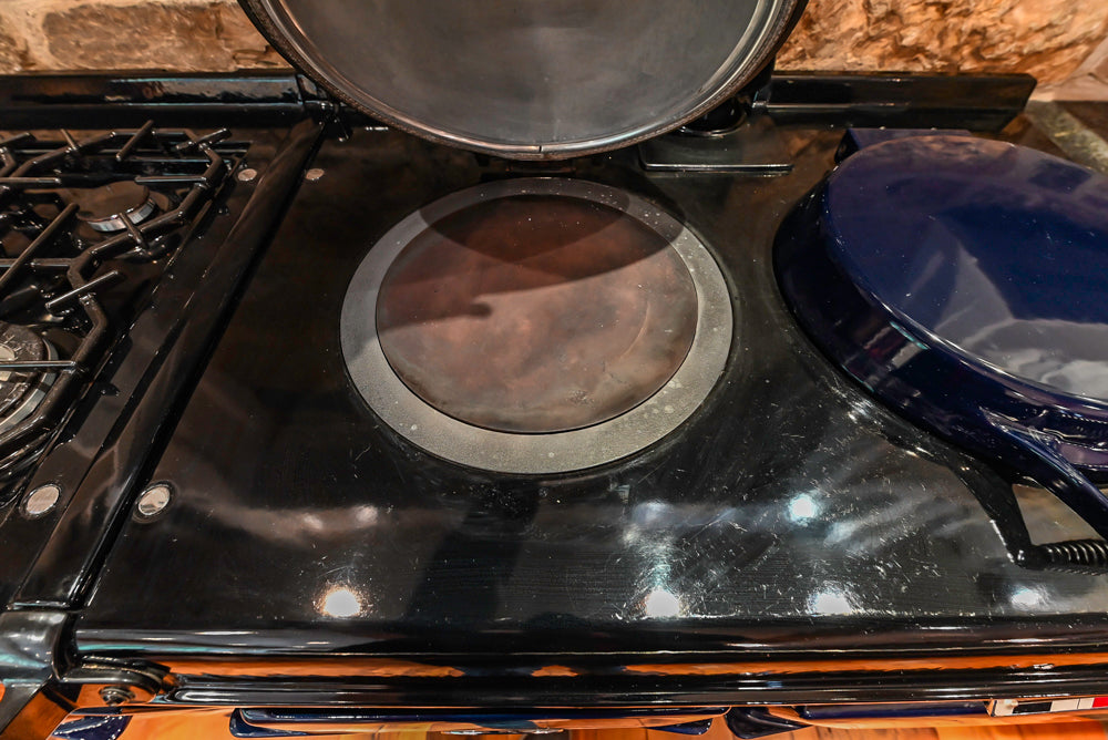 Rustic Traditional White & Navy Kitchen with Black AGA Range, Wood Top Island & Soapstone Countertops