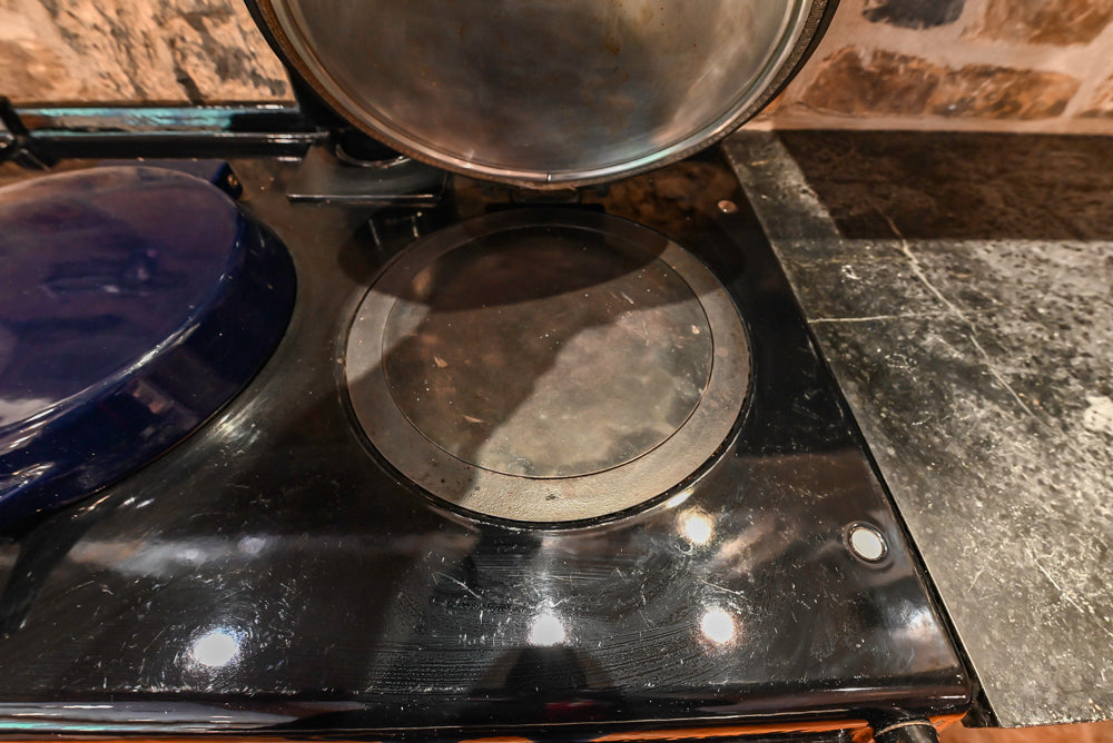 Rustic Traditional White & Navy Kitchen with Black AGA Range, Wood Top Island & Soapstone Countertops