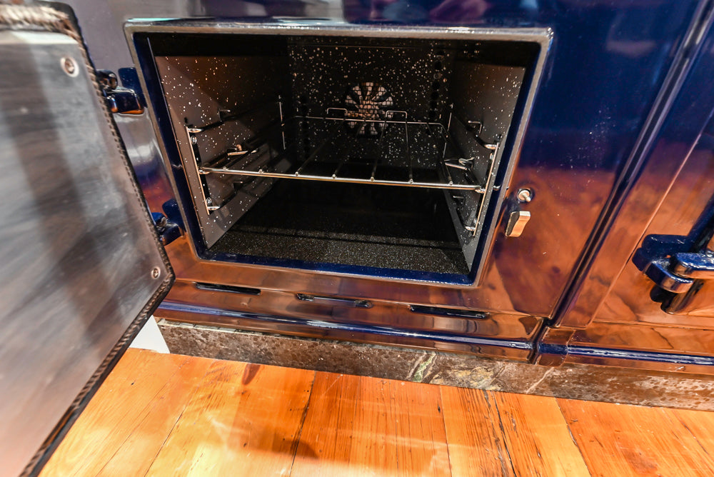 Rustic Traditional White & Navy Kitchen with Black AGA Range, Wood Top Island & Soapstone Countertops