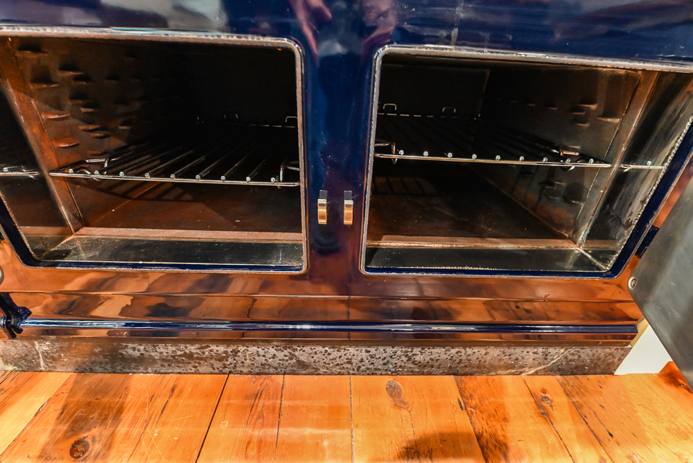 Rustic Traditional White & Navy Kitchen with Black AGA Range, Wood Top Island & Soapstone Countertops