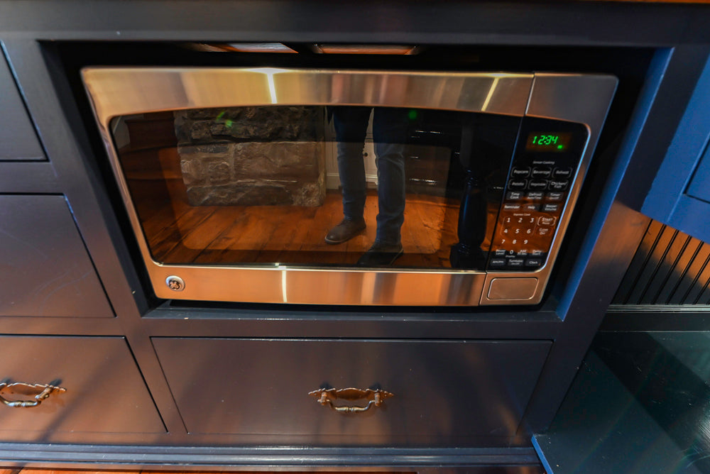 Rustic Traditional White & Navy Kitchen with Black AGA Range, Wood Top Island & Soapstone Countertops