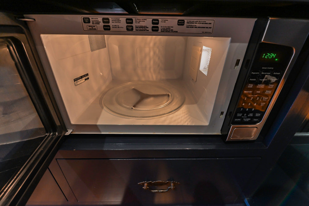 Rustic Traditional White & Navy Kitchen with Black AGA Range, Wood Top Island & Soapstone Countertops