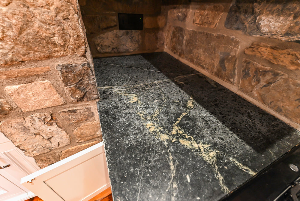 Rustic Traditional White & Navy Kitchen with Black AGA Range, Wood Top Island & Soapstone Countertops