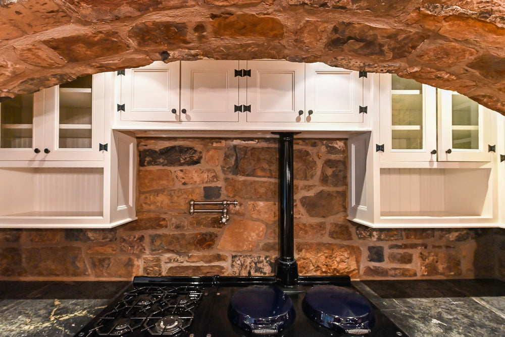 Rustic Traditional White & Navy Kitchen with Black AGA Range, Wood Top Island & Soapstone Countertops