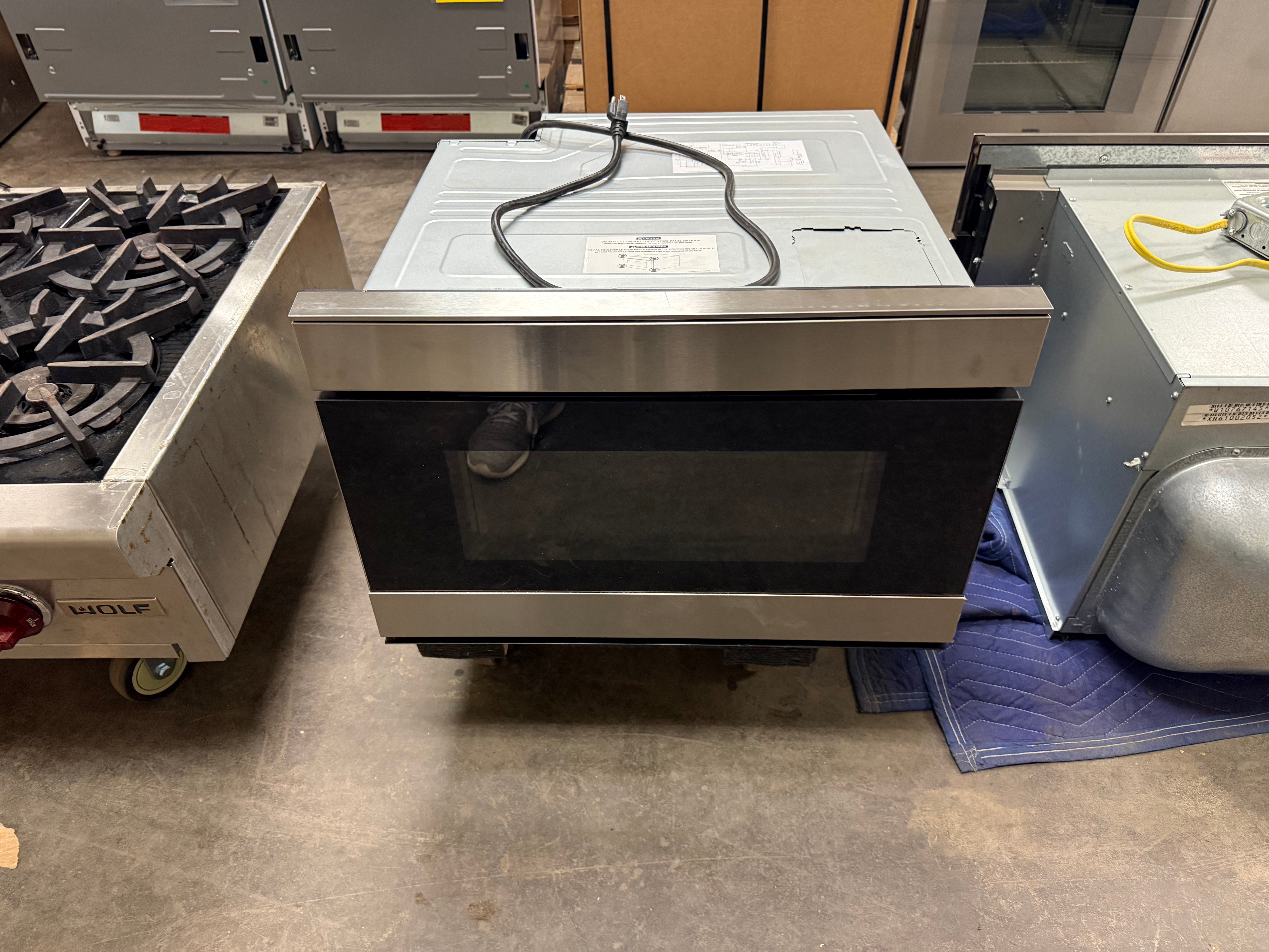 Sharp 24 inch smart microwave drawer in stainless steel installed in cabinetry
