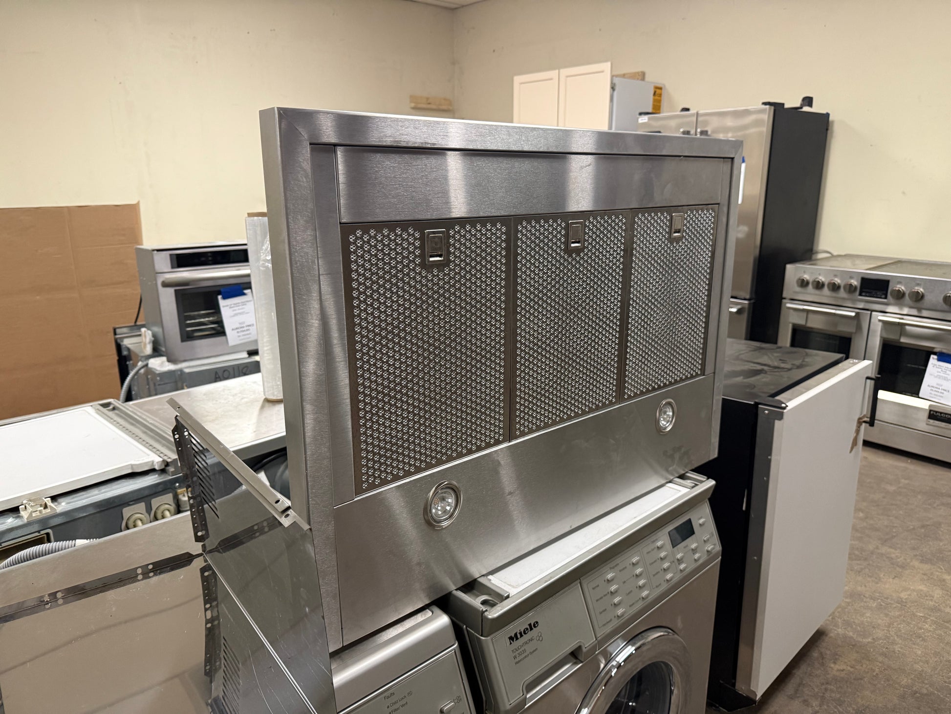 Close up of blue backlit touch controls on XO XOV36KS range hood