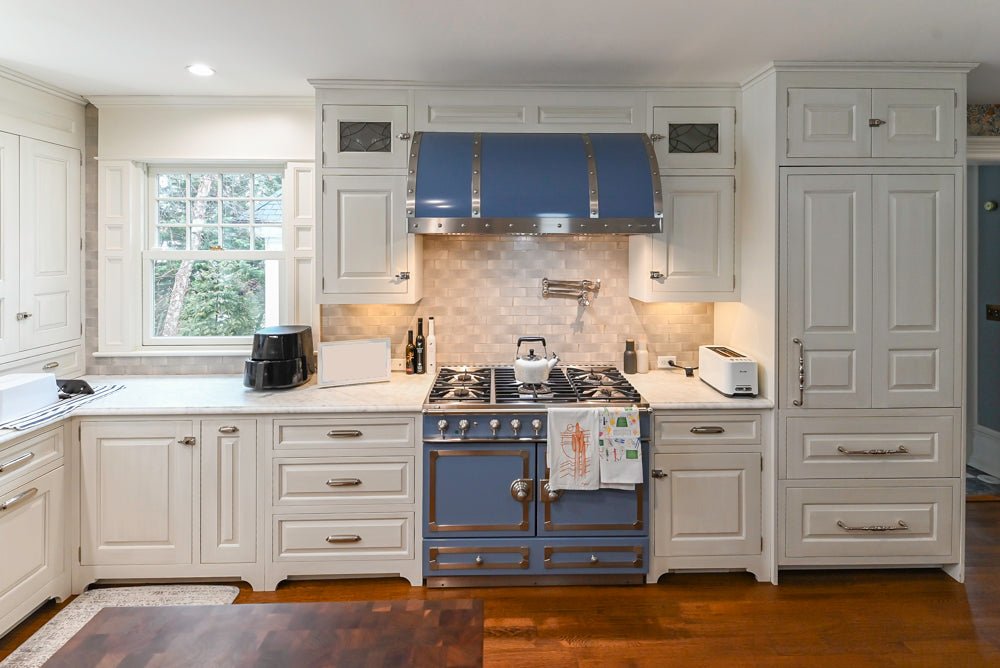 Traditional White Kitchen with Island, Marble Countertops and La Cornue Range with Matching Hood