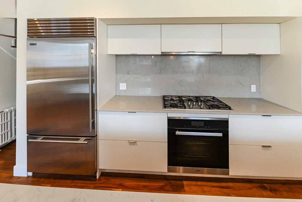 Modern Matte White Kitchen with Waterfall Island, Quartz Countertops & Miele Appliances