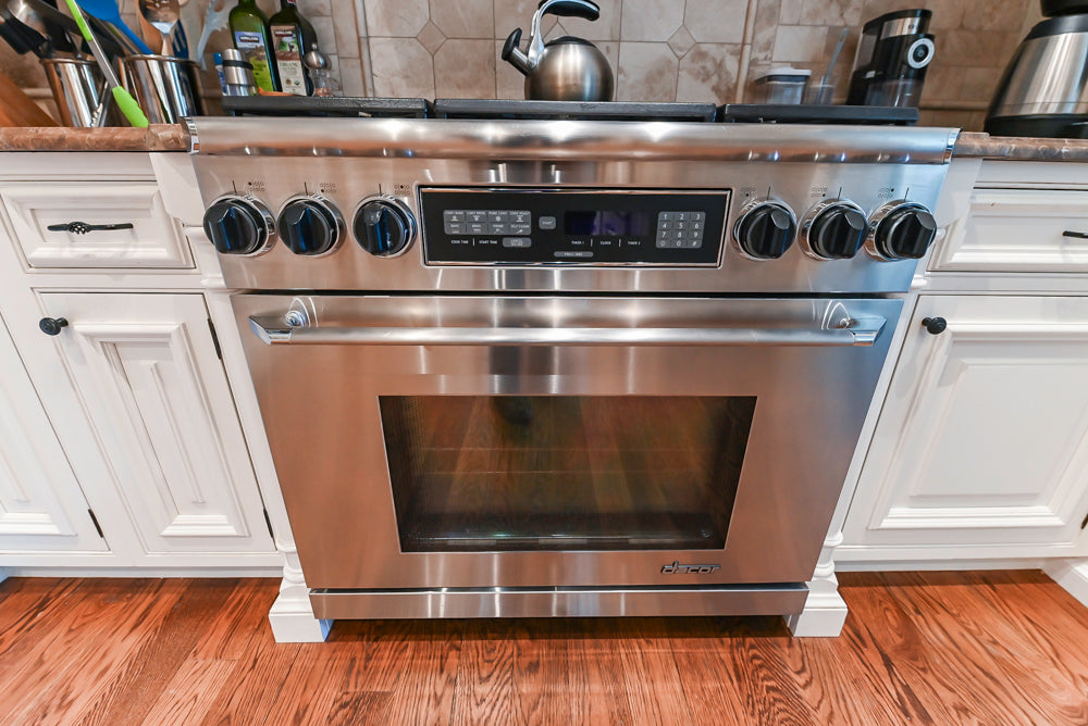 Quakermaid Traditional White Kitchen with Marble Countertops and Luxe Appliances
