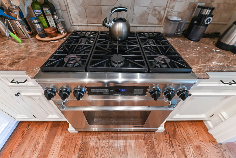 Quakermaid Traditional White Kitchen with Marble Countertops and Luxe Appliances