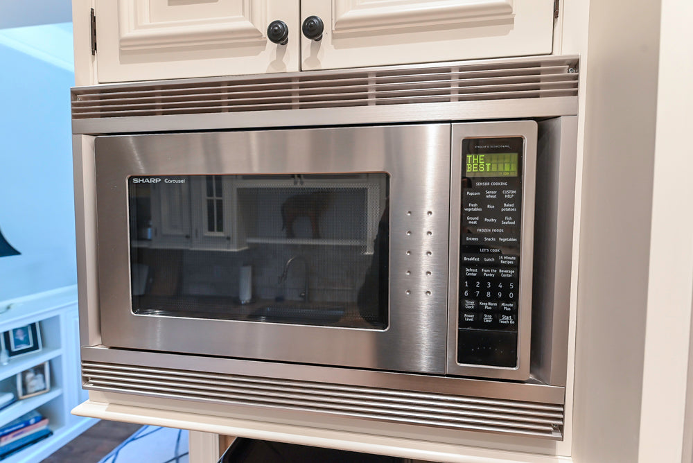 Quakermaid Traditional White Kitchen with Marble Countertops and Luxe Appliances
