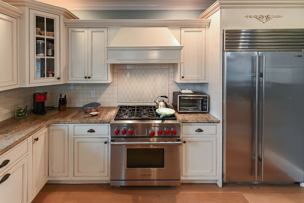 Omega Traditional Light Cream Kitchen with Island, Desk Area and Sub-Zero & Wolf Range