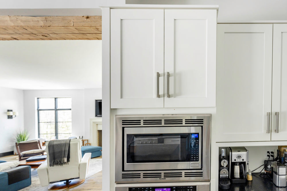 Transitional White Kitchen with Marble Waterfall Island and Thermador Appliances