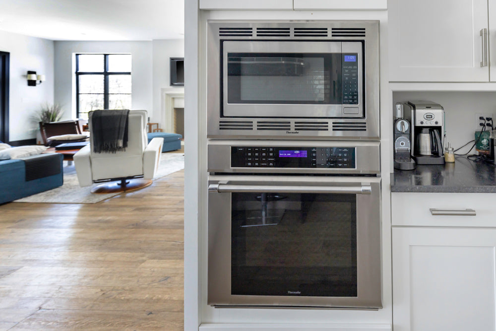 Transitional White Kitchen with Marble Waterfall Island and Thermador Appliances